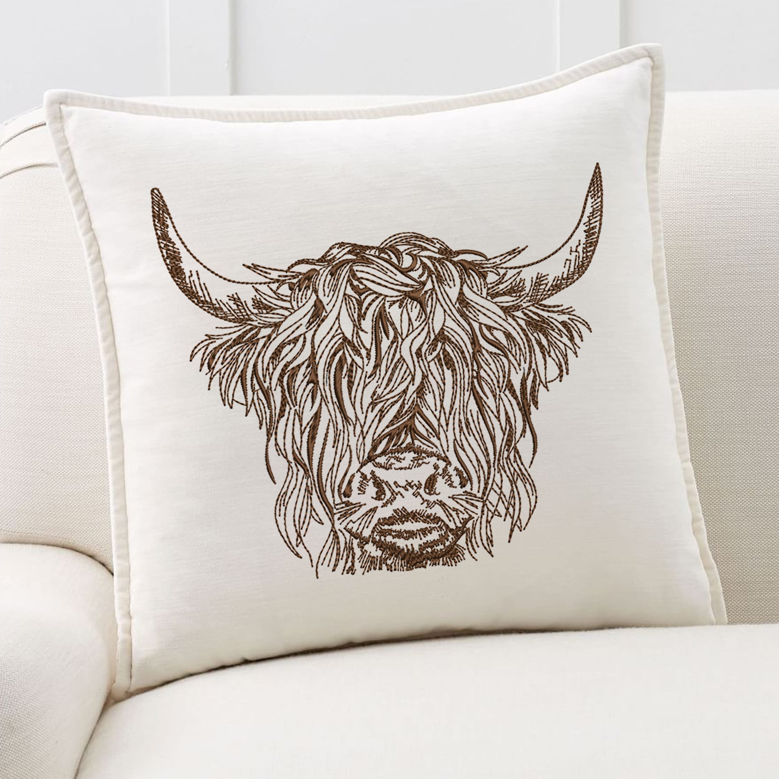 Scottish Highland Cow for Machine Embroidery embroidered on a pillow