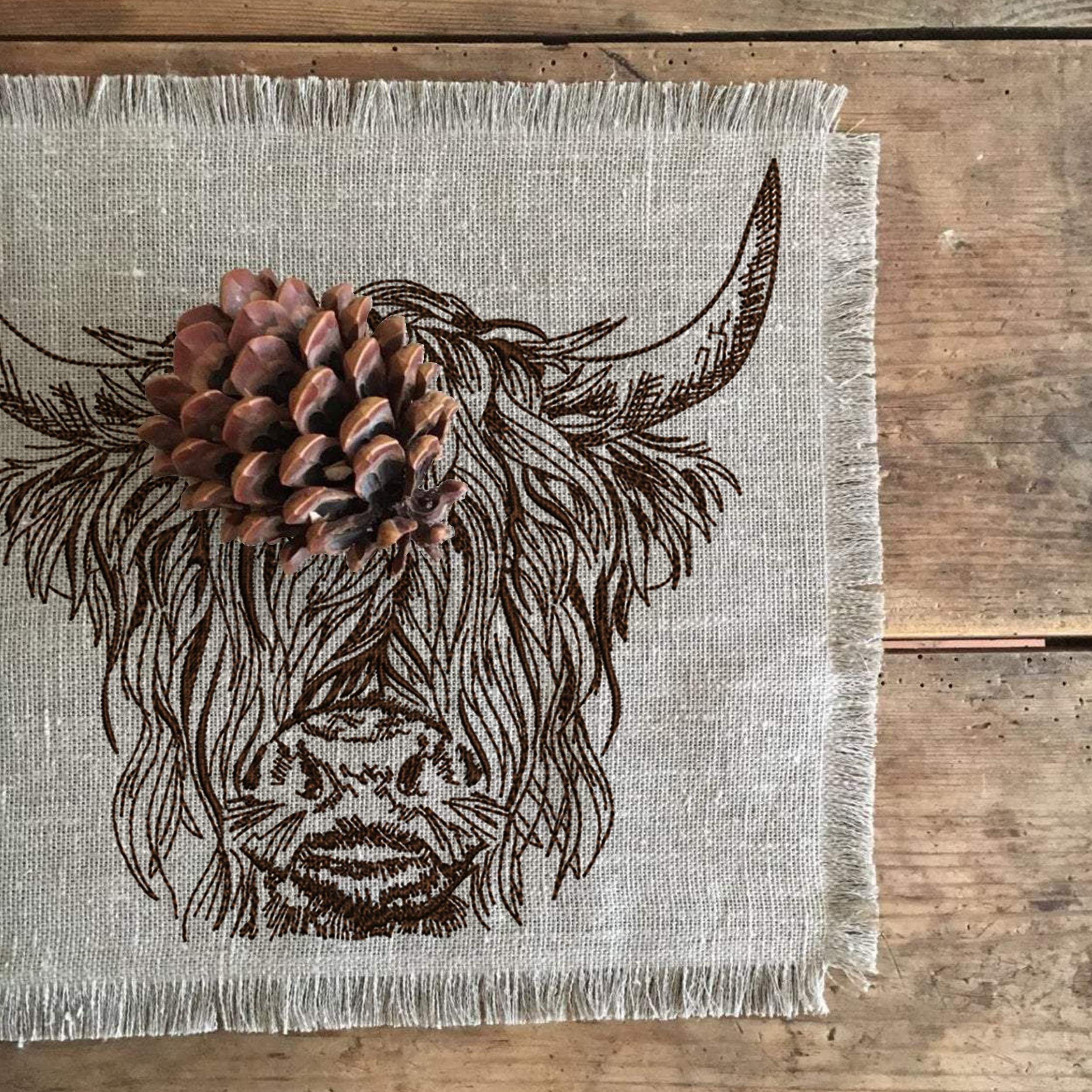 Scottish Highland Cow for Machine Embroidery embroidered on a napkin