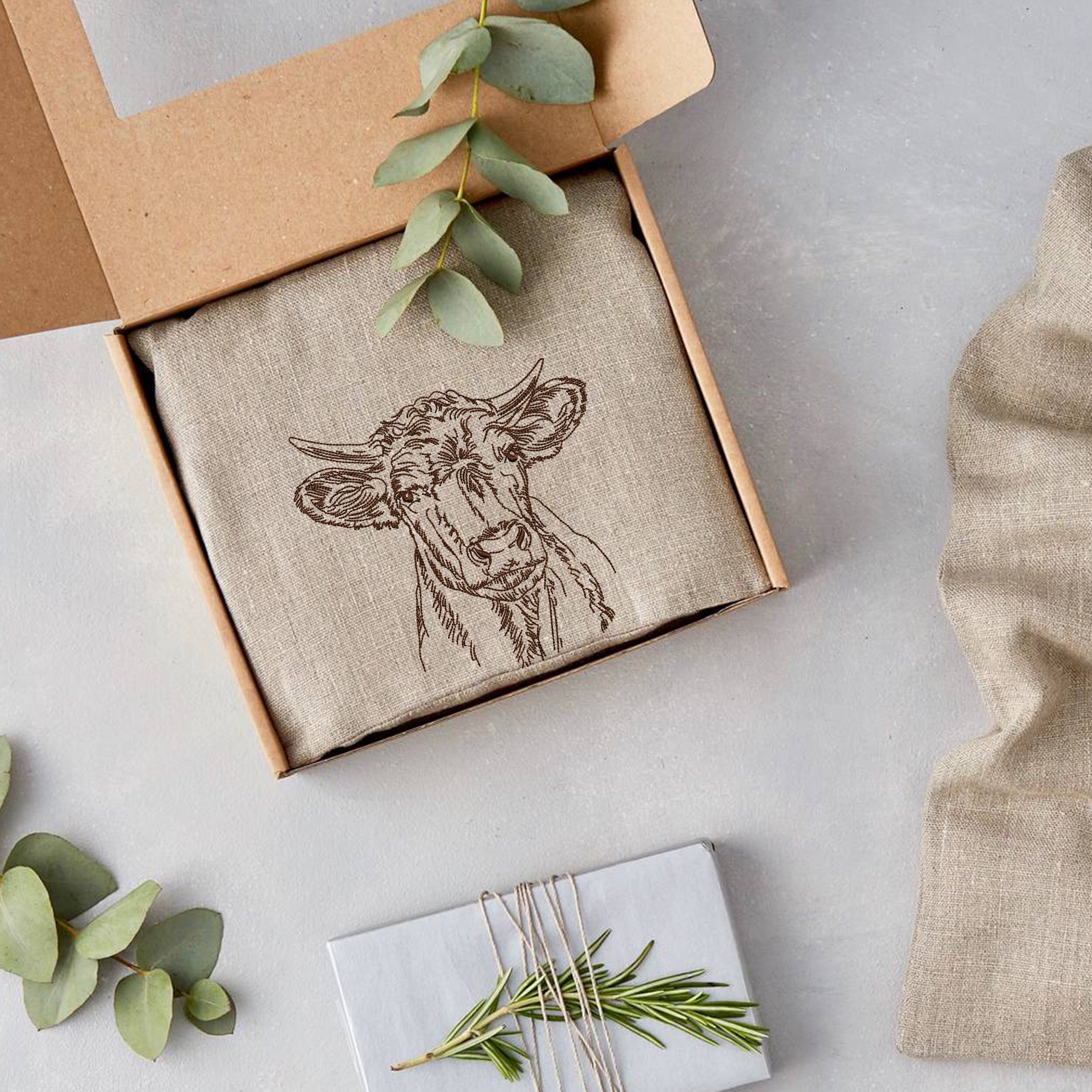 Meadow Cow Machine Embroidery Design embroidered on a gift box