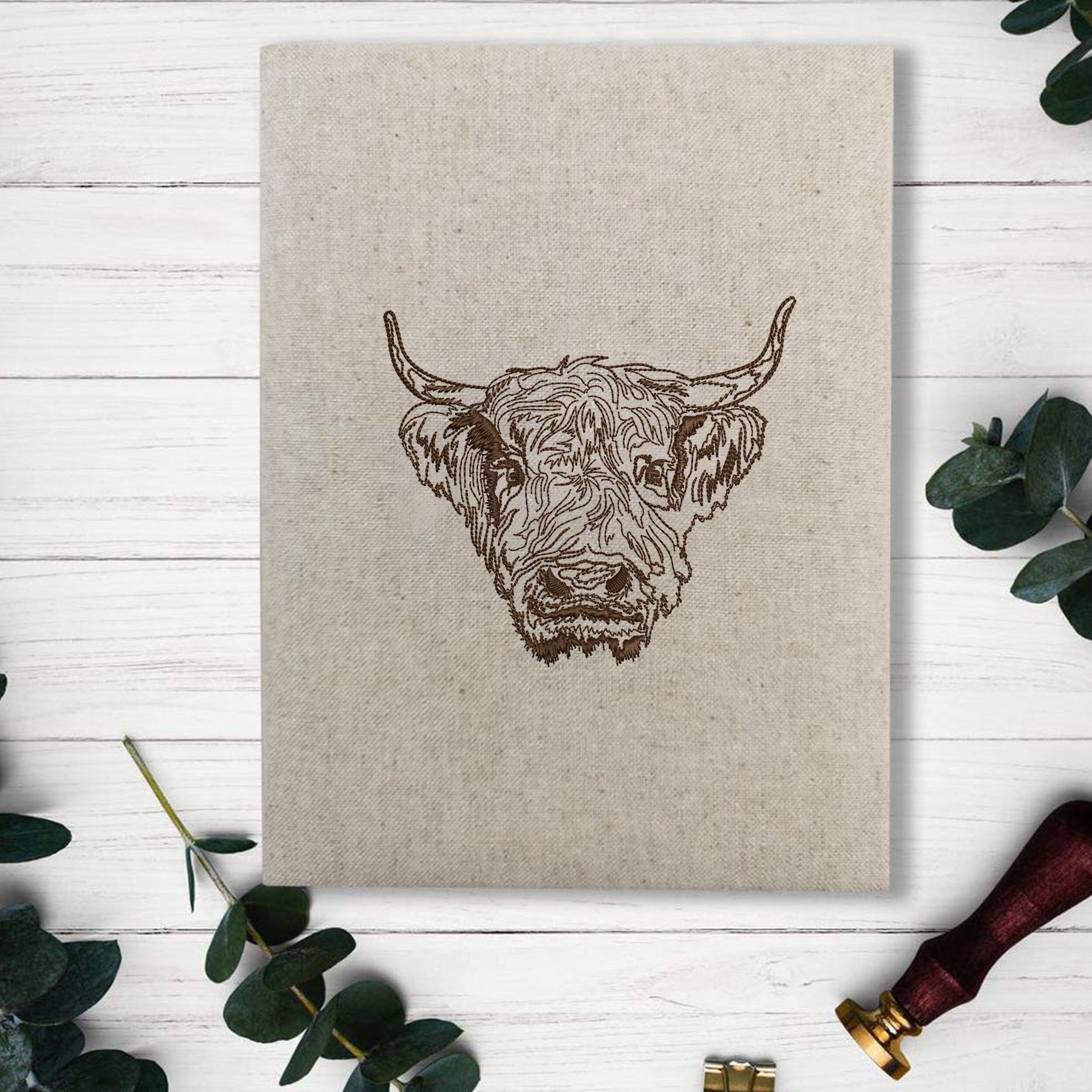 Scottish Highland Cow Machine Embroidery Design embroidered on a book cover