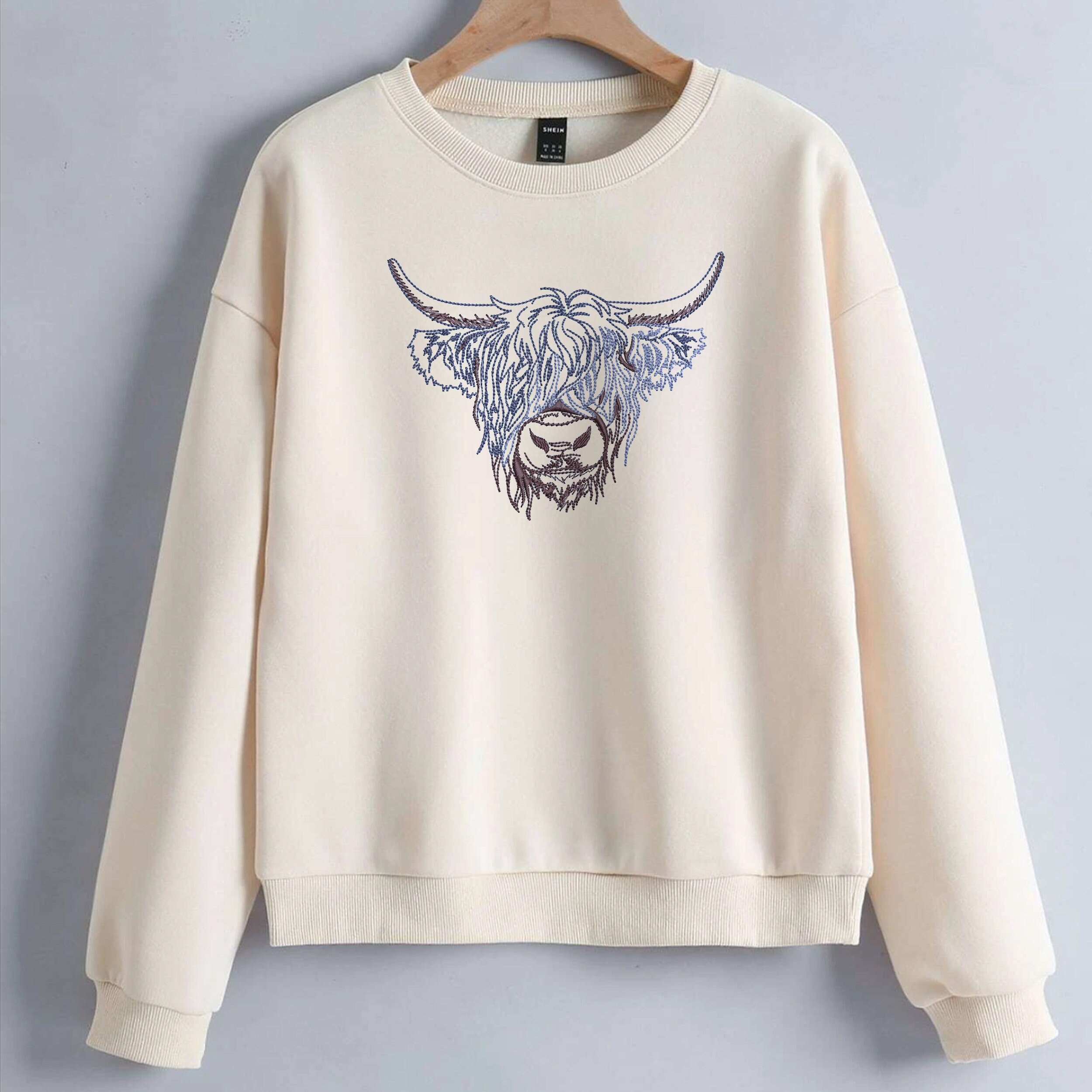 Scottish Highland Cow Machine Embroidery Design ZIP File embroidered on a sweater