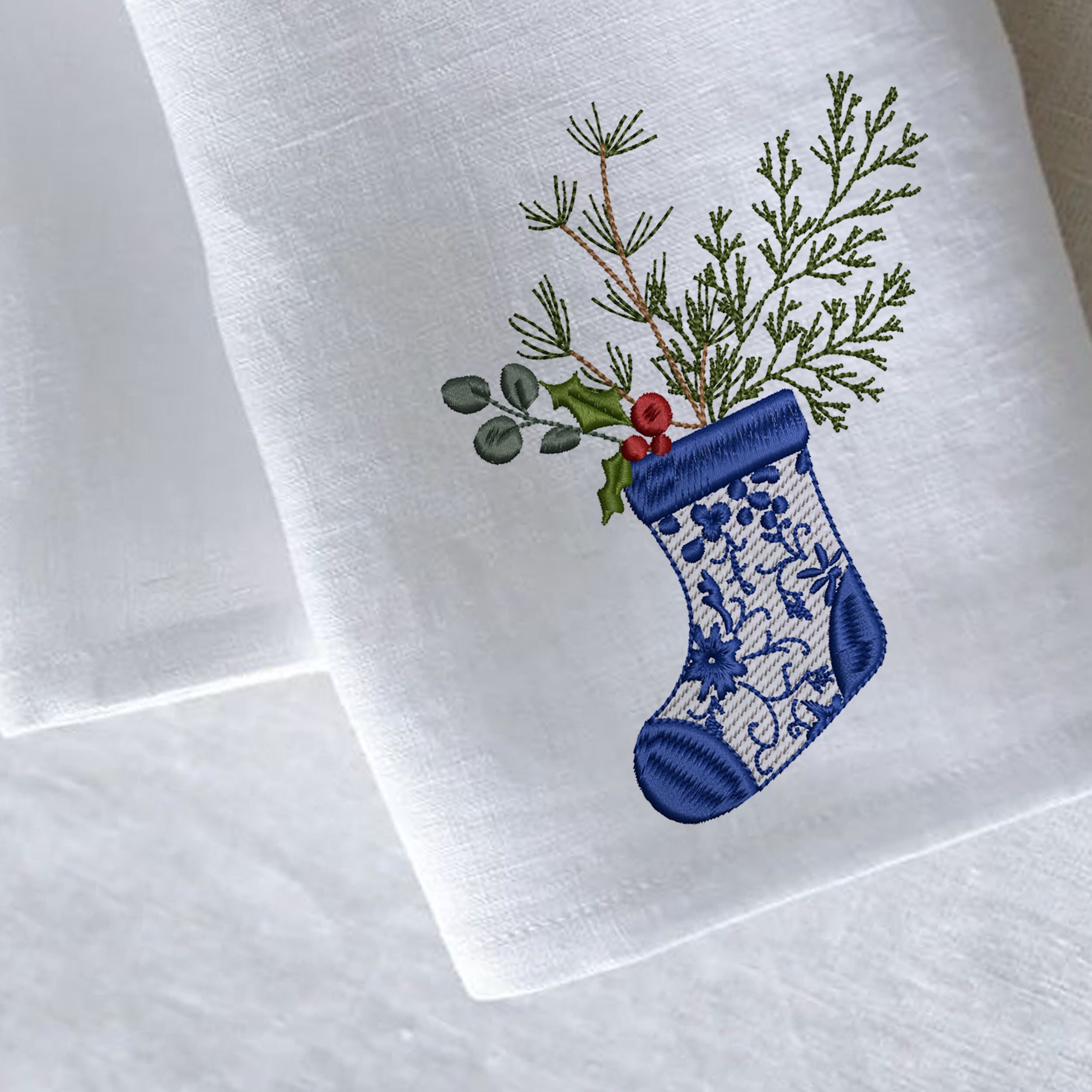 Chinoiserie Christmas Tree Stocking Machine Embroidery Design embroidered on a linen napkin