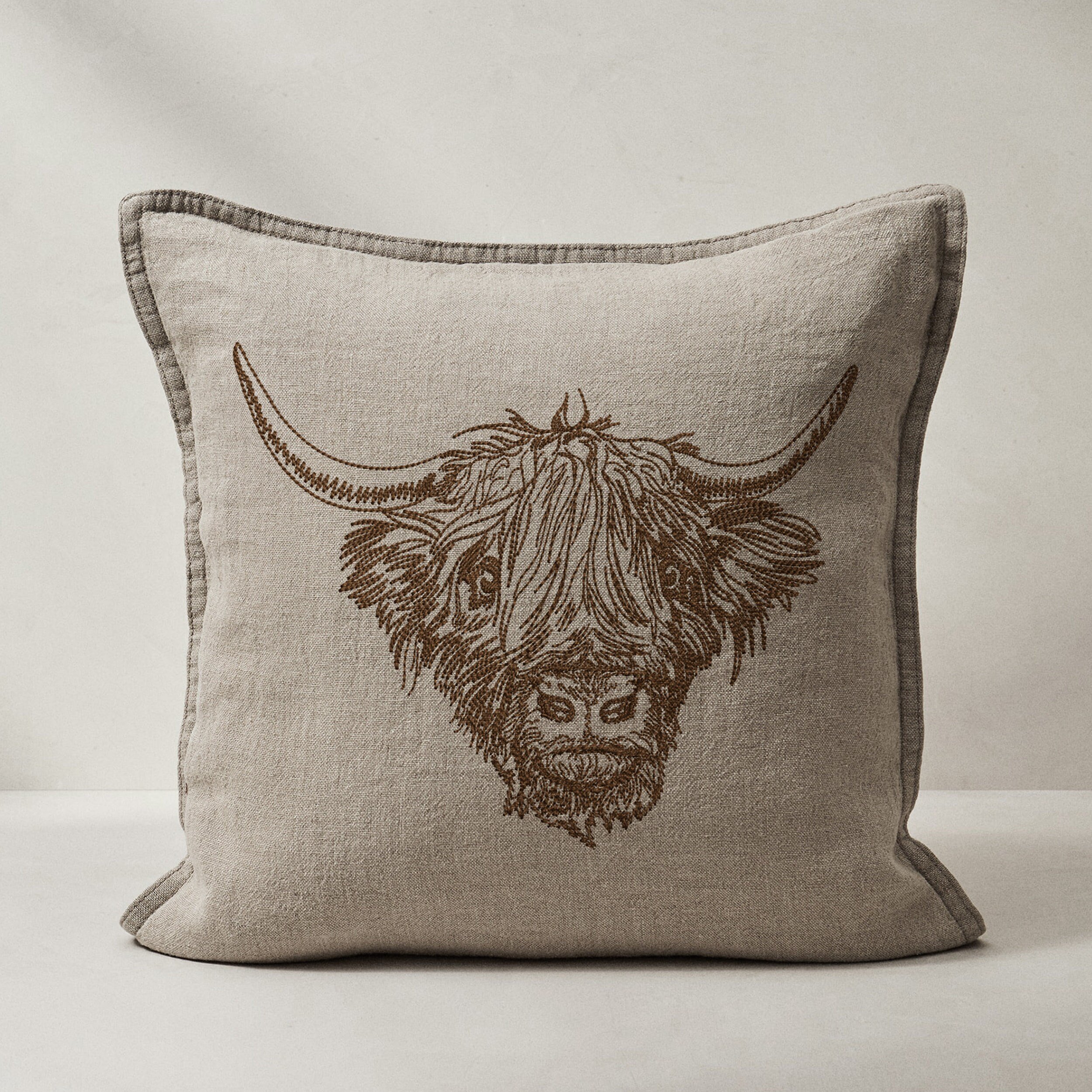 Scottish Highland Cow for Machine Embroidery embroidered on a pillow