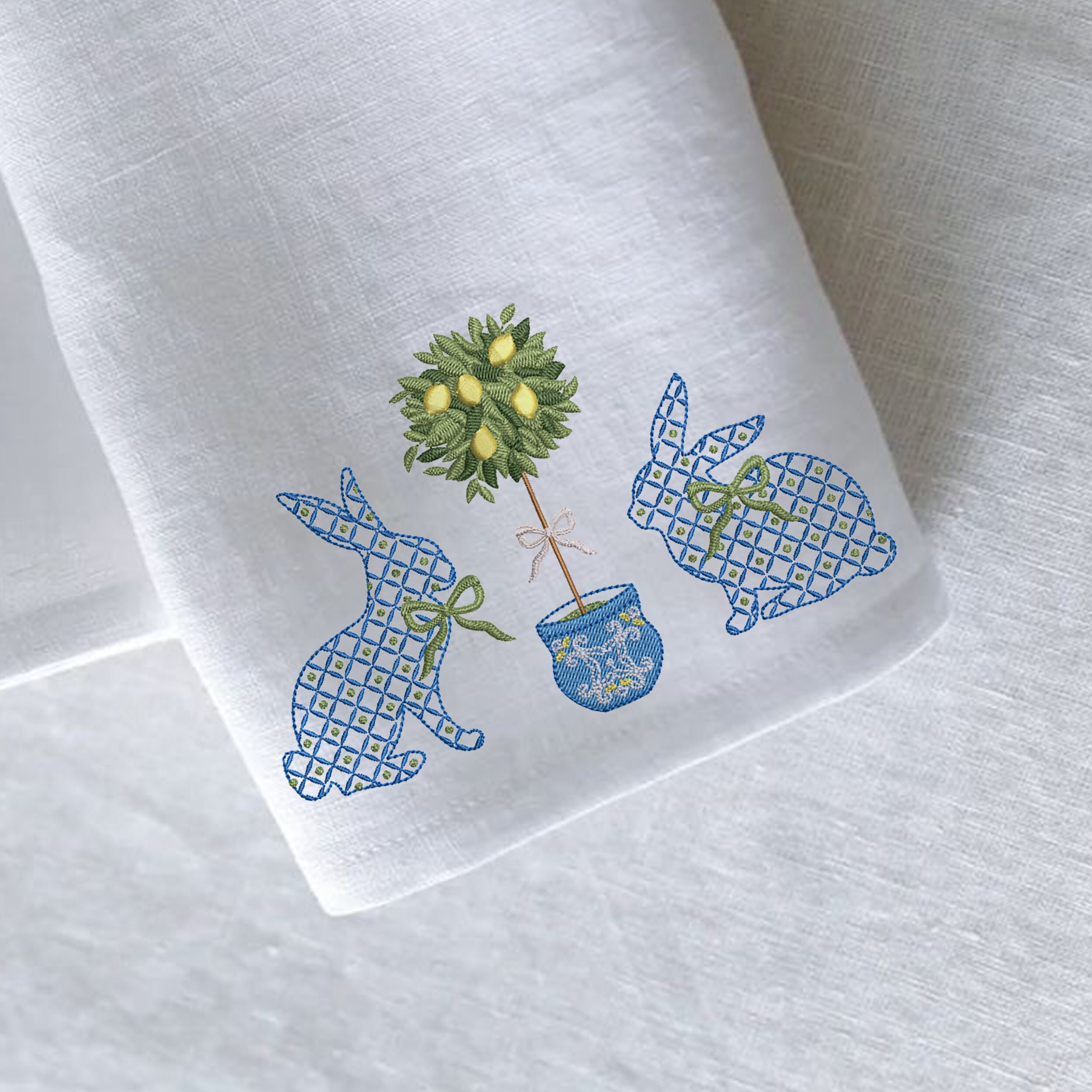 Blue and White Easter Bunnies with a Chinoiserie Lemon Tree for Machine Embroidery embroidered on a napkin