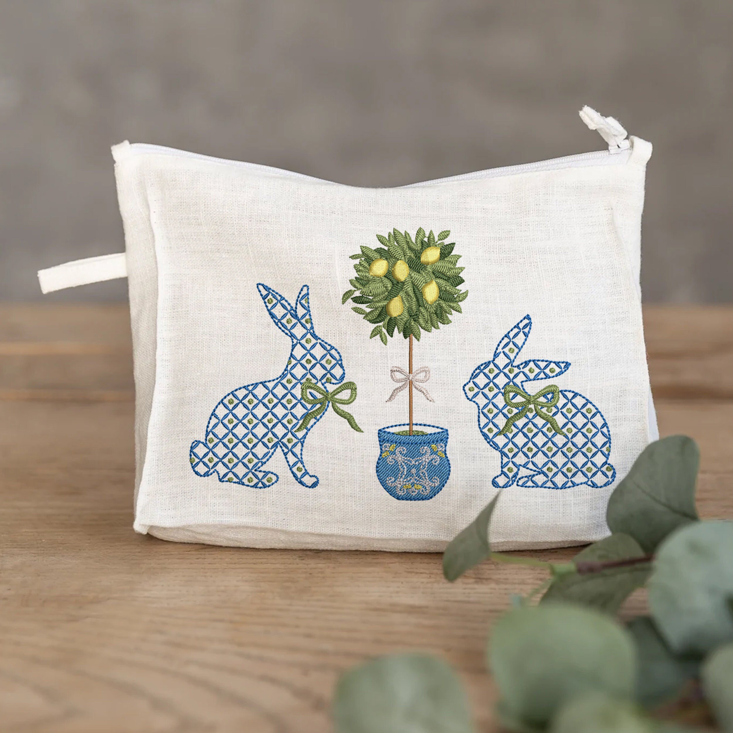 Blue and White Easter Bunnies with a Chinoiserie Lemon Tree for Machine Embroidery embroidered on a pouch