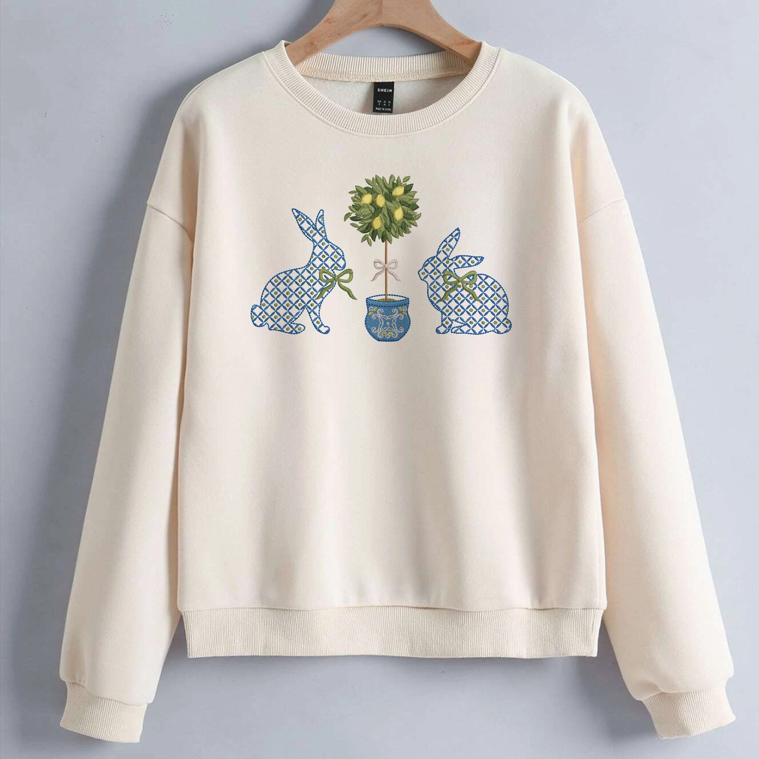 Blue and White Easter Bunnies with a Chinoiserie Lemon Tree for Machine Embroidery embroidered on a sweater