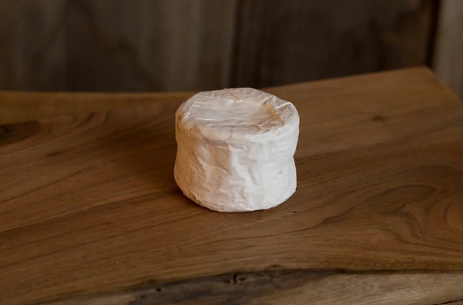 Piece of round goat cheese