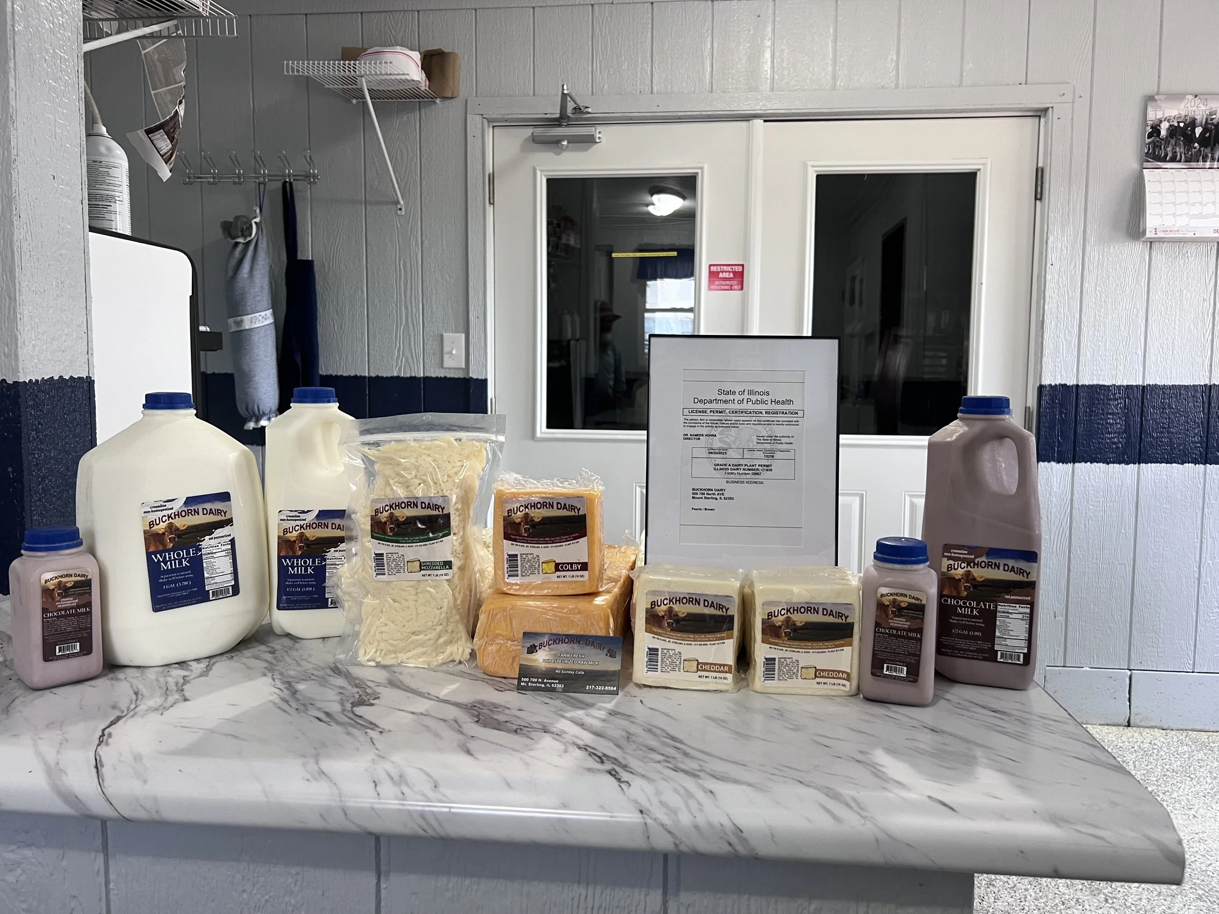Milk and cheese products laid out on a countertop