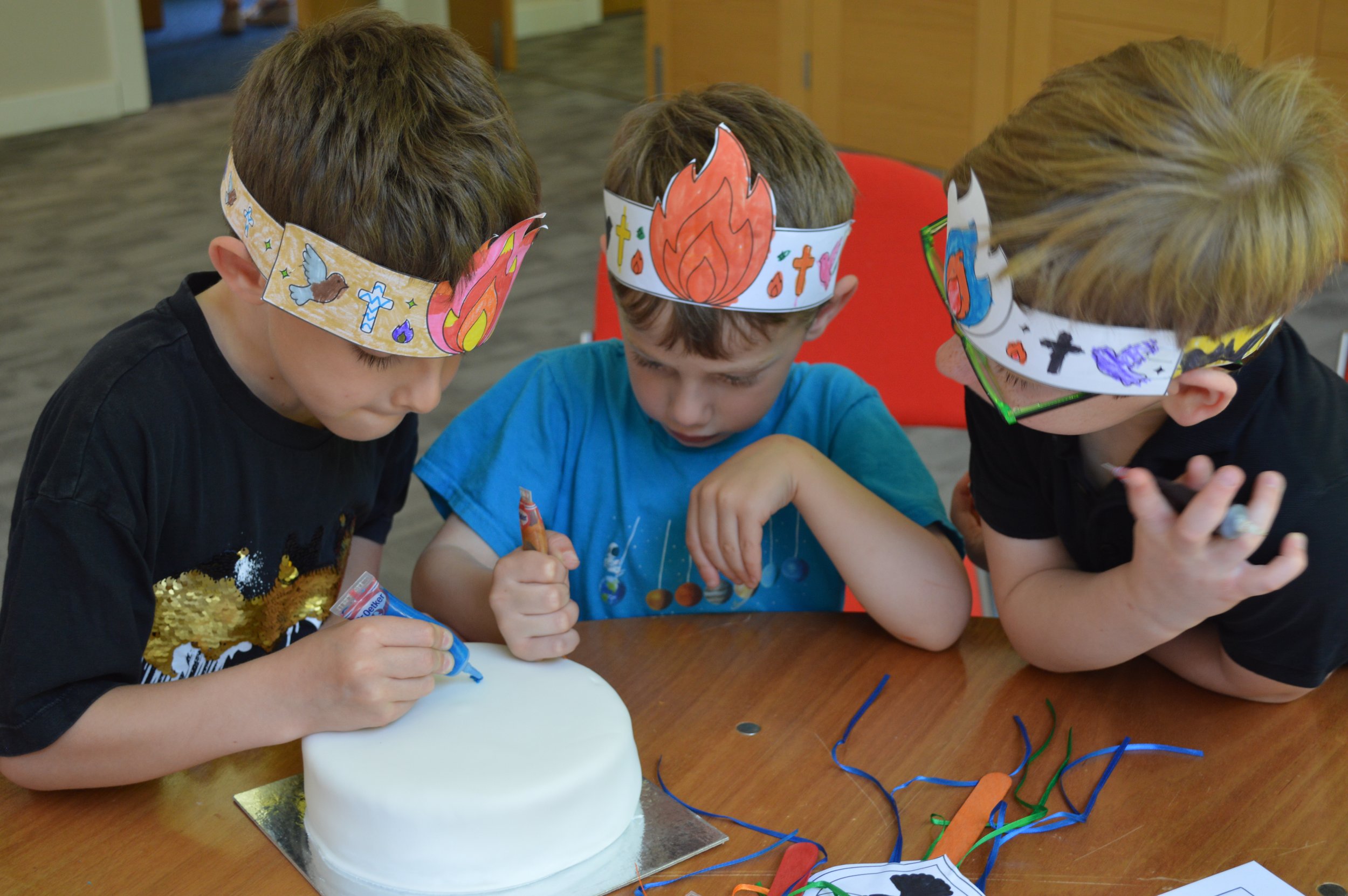 Our young Fun & Faith members help celebrate the churches birthday by decorating the cake