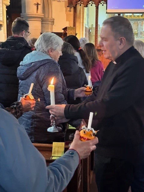 David lighting the candles at Christingle Service