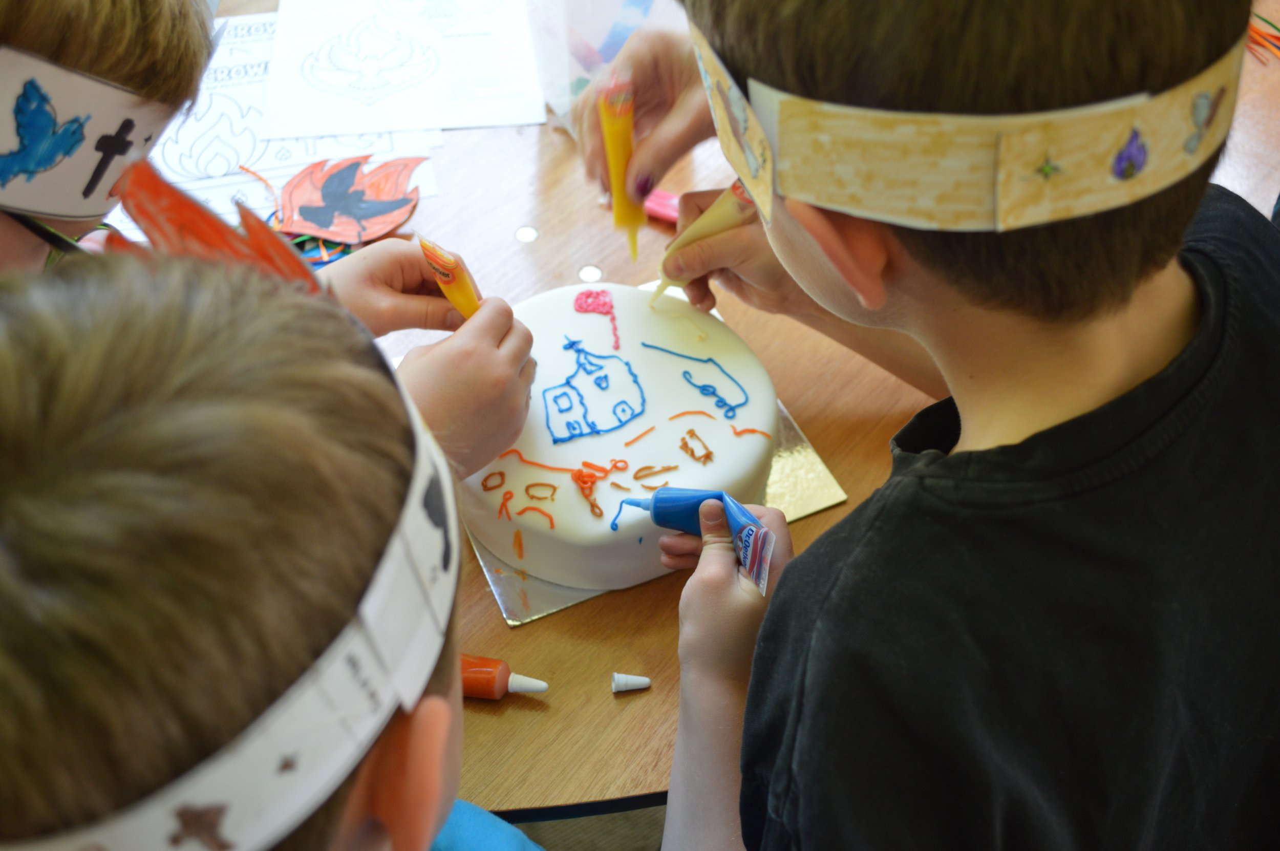 Our young Fun & Faith members help celebrate the churches birthday by decorating the cake