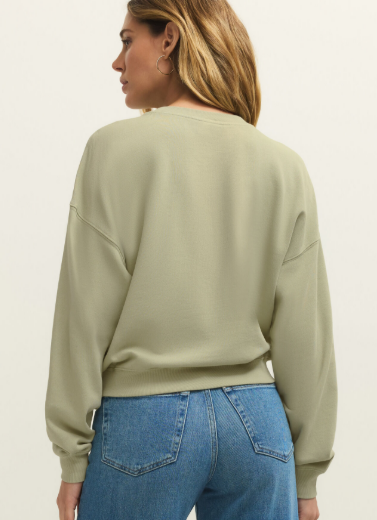 A relaxed crewneck sweatshirt made from soft brushed fleece with a statement Ciao graphic—perfect for casual days or travel.