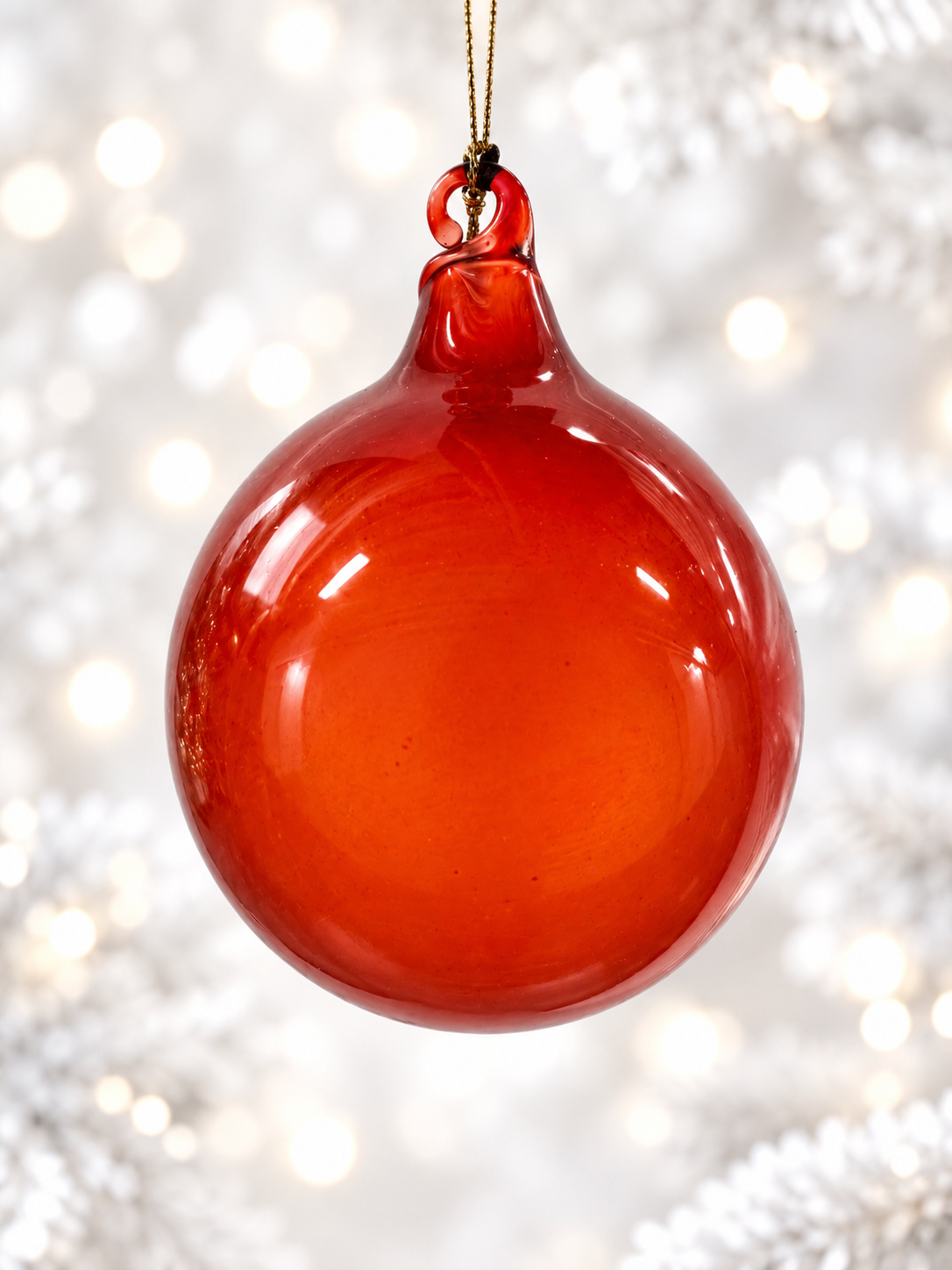 Glossy red-orange bauble on white.png