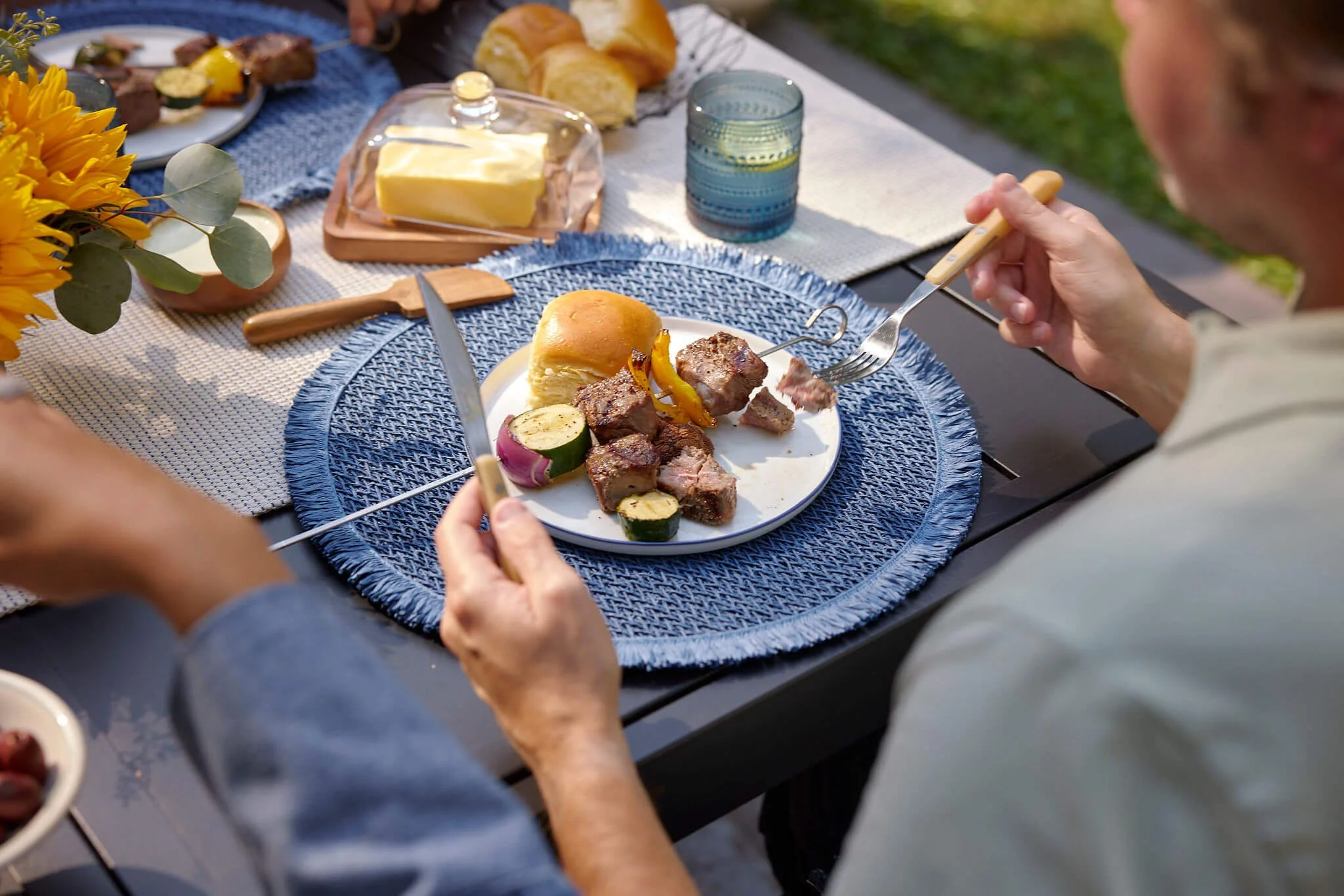 man eating steak at a bbq
