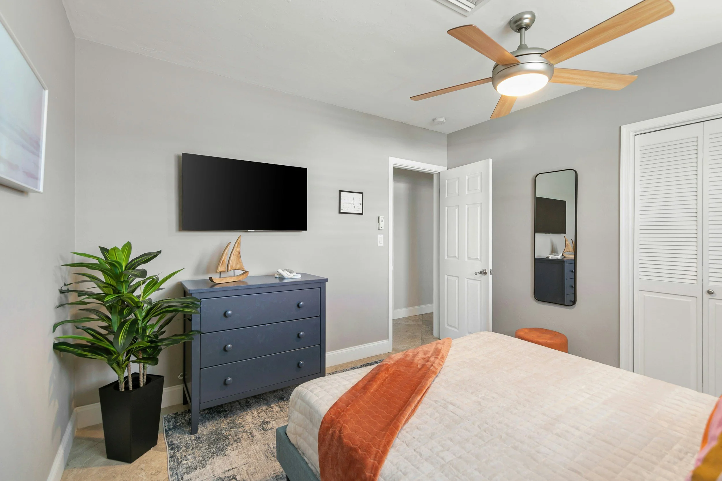 Ceiling fan with an integrated light installed in a residential bedroom