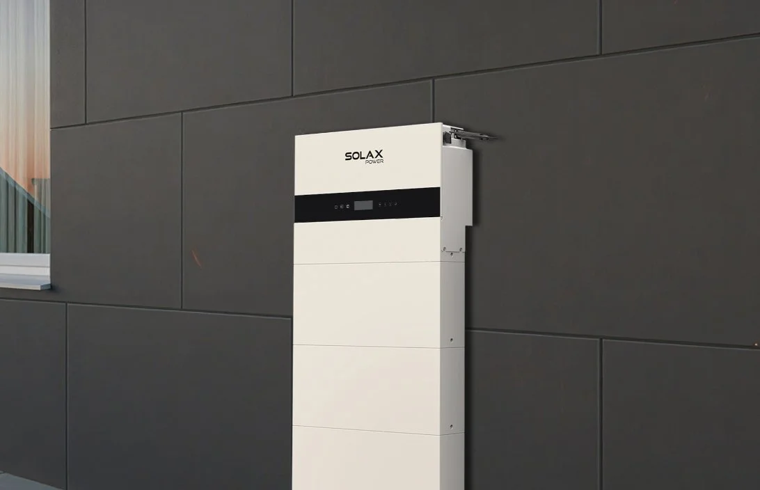 SolaX residential battery storage unit positioned against an exterior wall