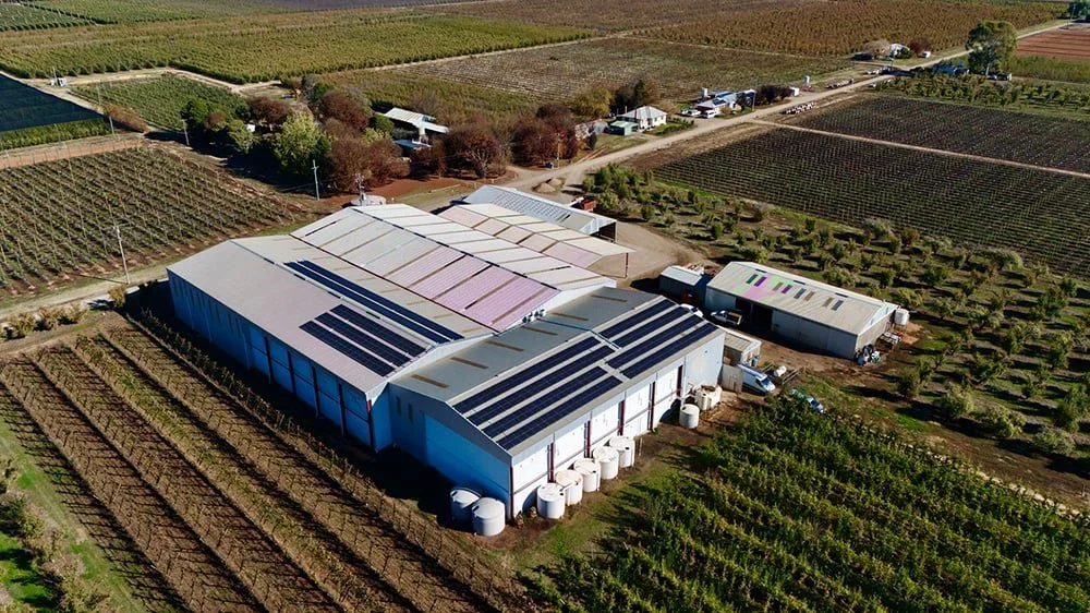 Aerial view of rooftop solar panels on a rural agricultural property