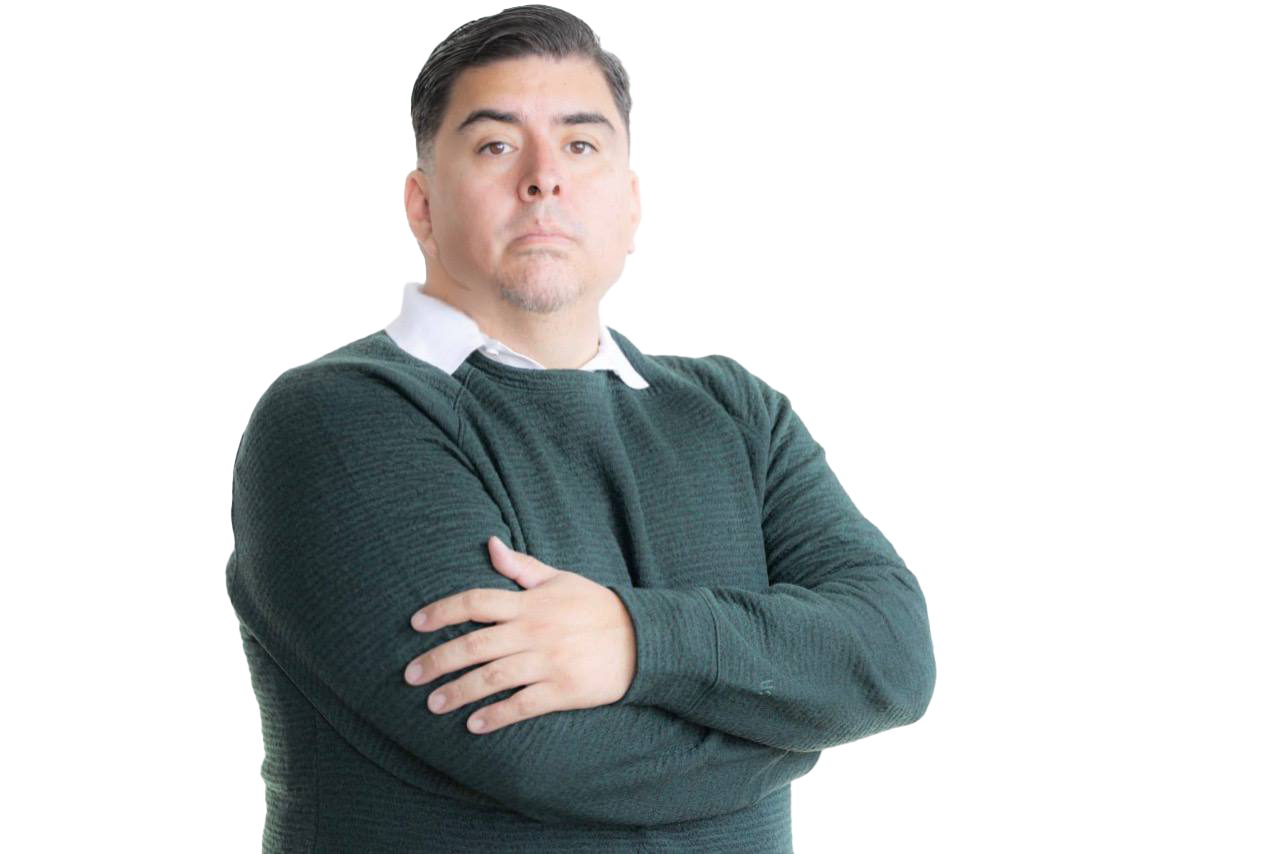 Man with crossed arms wearing a dark green sweater over a white collared shirt, standing against a gradient background with digital glitch effects.