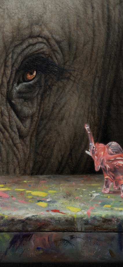 Close-up of an elephant's eye with a small pink figurine of an elephant on a colorful surface.
