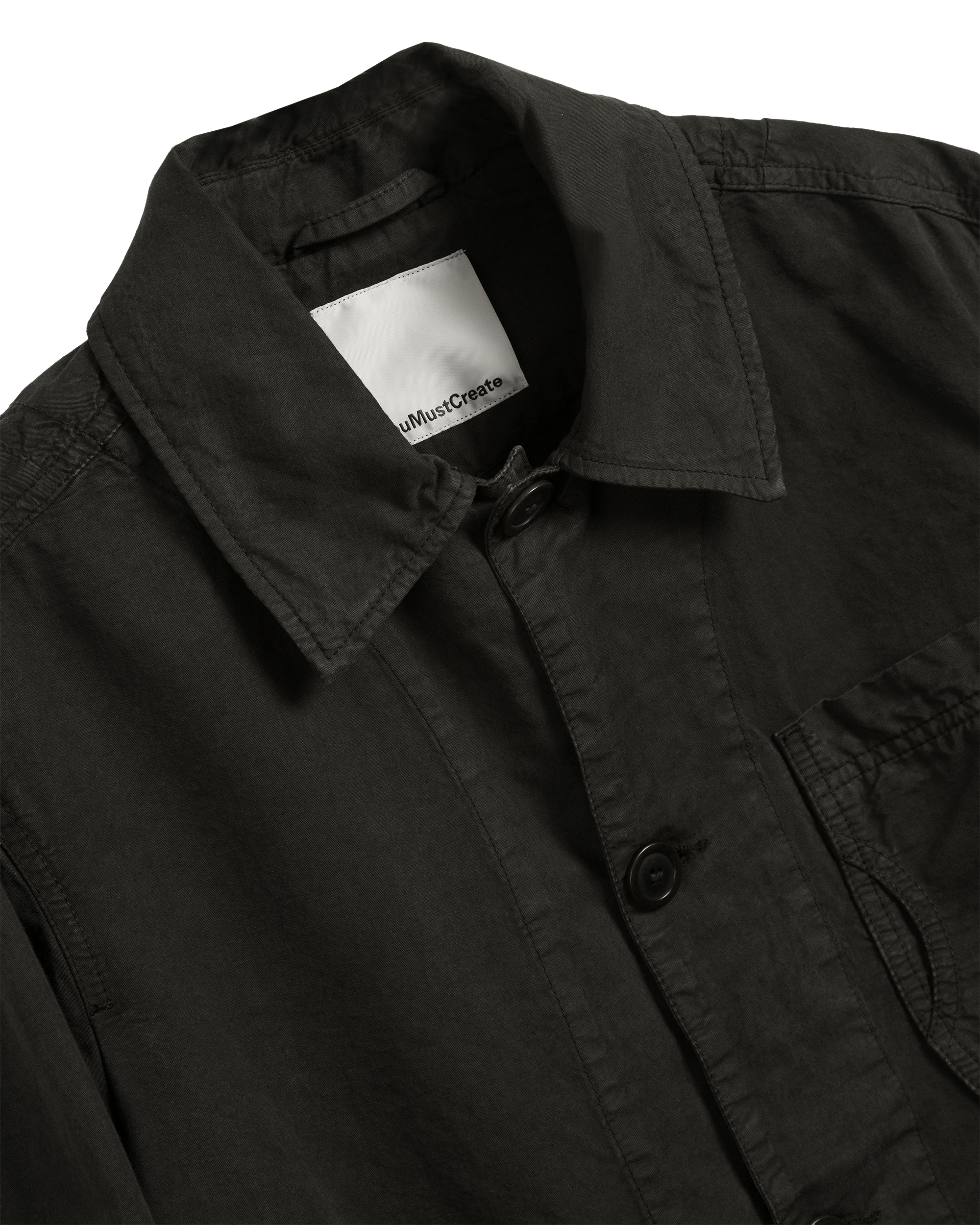 Shop the YMC Construction Jacket in dark green. Crafted from a cotton and linen blend, this lightweight workwear-inspired jacket offers durability, comfort, and timeless style.