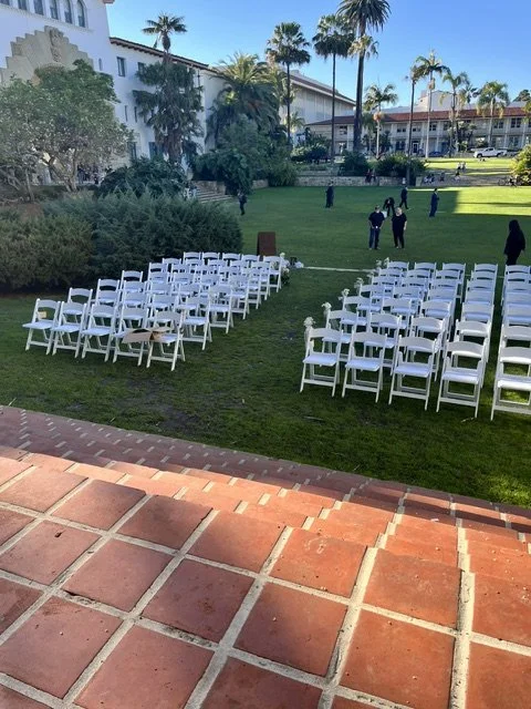 White garden chairs lined up for a wedding ceremony at Santa Barbara Courthouse Sunken Gardens.