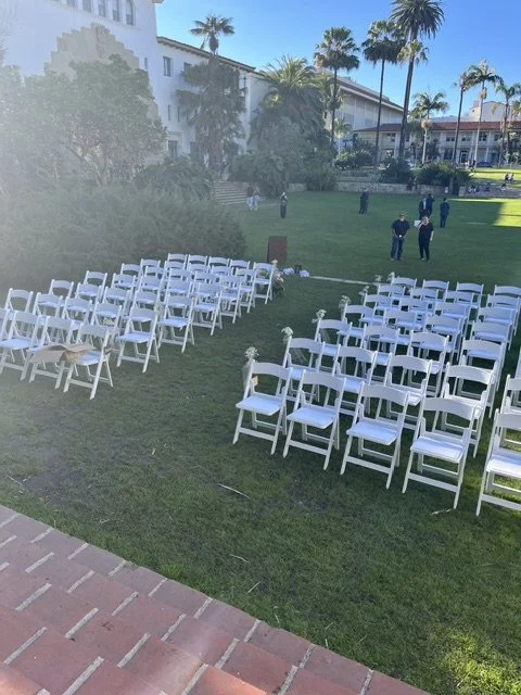 White garden chairs lined up for a wedding ceremony at Santa Barbara Courthouse Sunken Gardens.