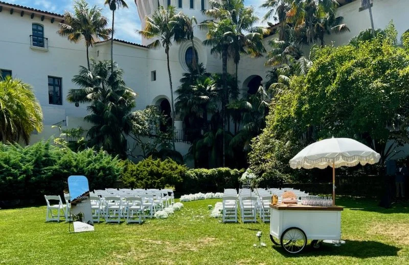 White garden chairs lined up for a wedding ceremony at Santa Barbara Courthouse Sunken Gardens.