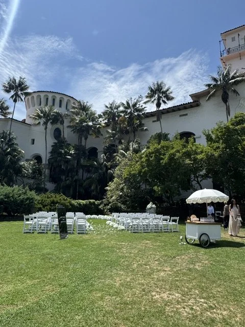 White garden chairs lined up for a wedding ceremony at Santa Barbara Courthouse Sunken Gardens.