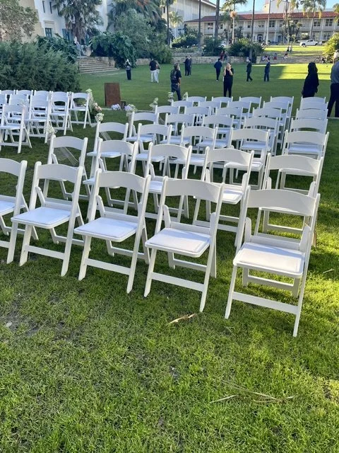 White garden chairs lined up for a wedding ceremony at Santa Barbara Courthouse Sunken Gardens.