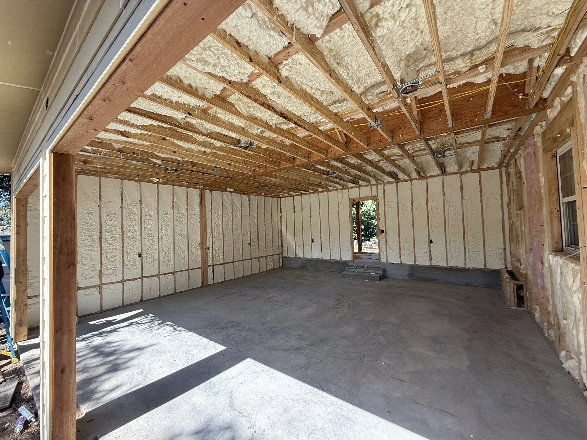 Spray foam insulation in the stud walls and roof deck of a wood-framed building
