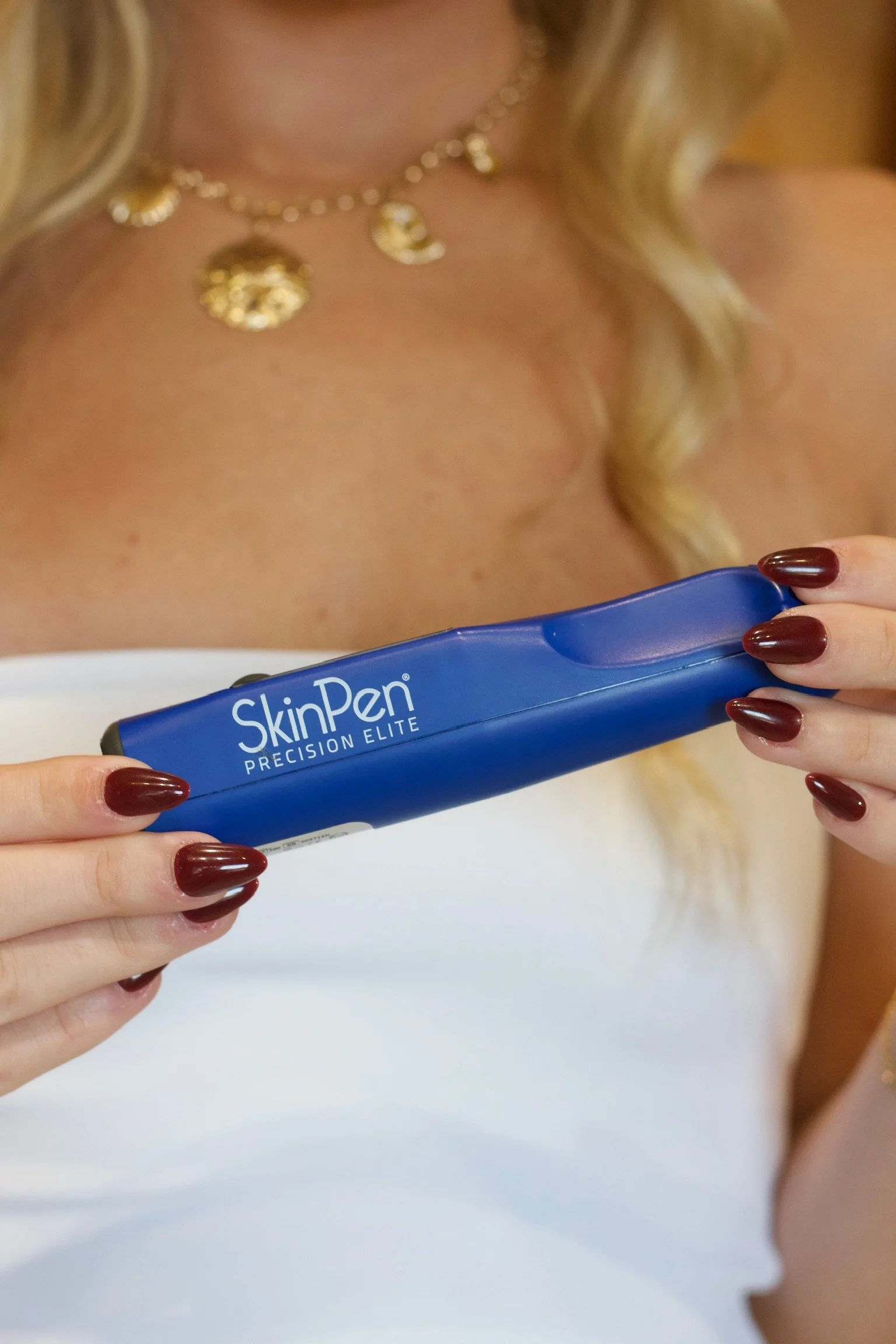 Esthetician Cameran holding a SkinPen Precision Elite for professional microneedling treatments in Kitty Hawk, NC