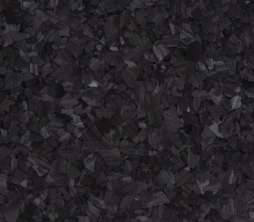 Close-up of black shredded paper or wood shavings.