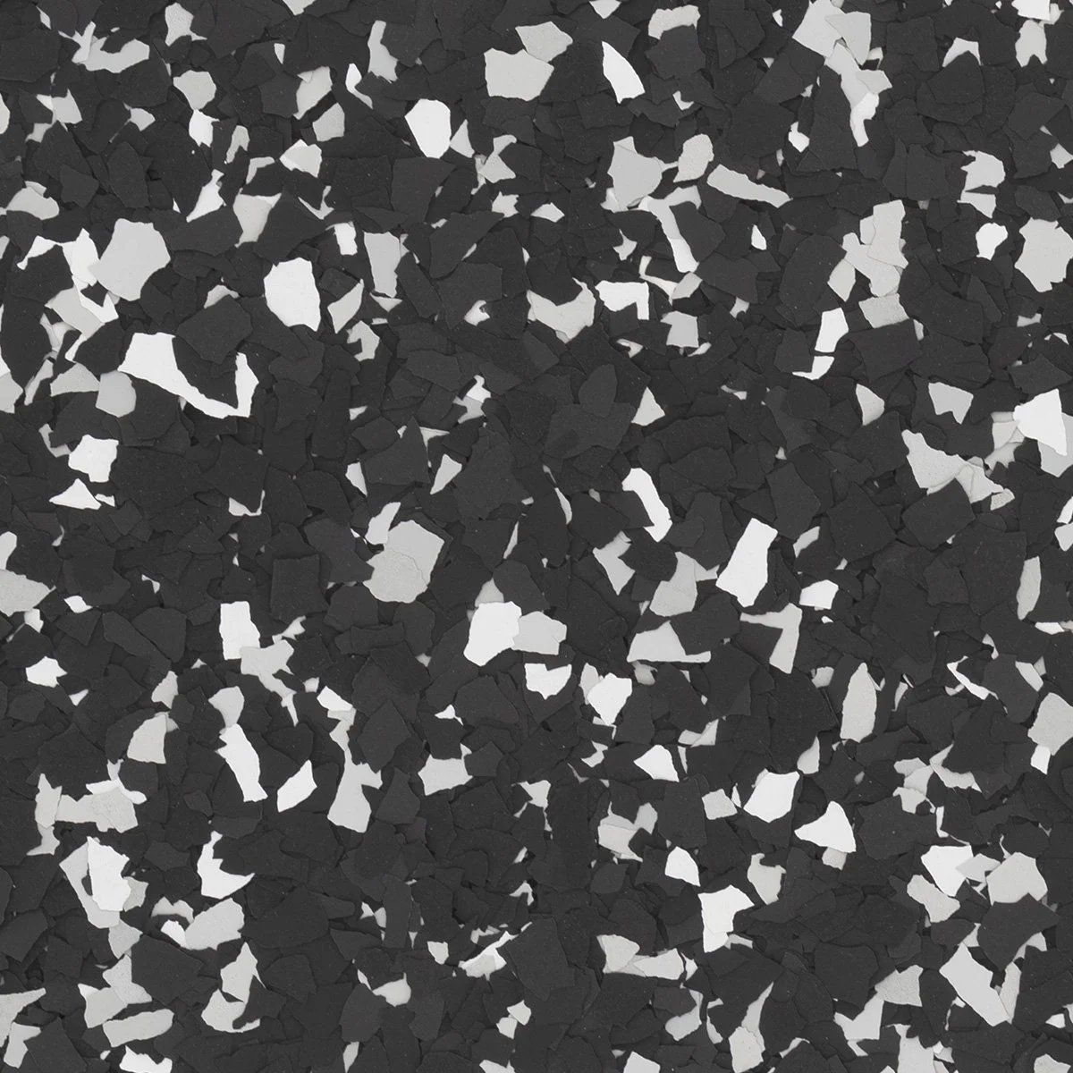 Close-up of black and white irregularly shaped small chips or fragments.