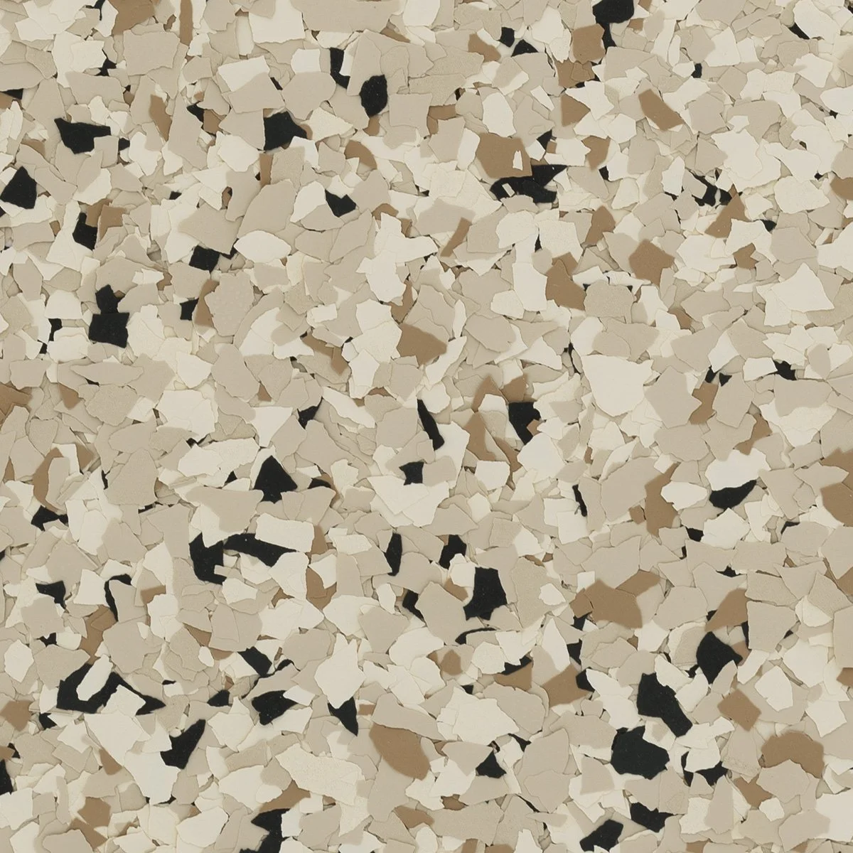 Close-up of multicolored confetti in beige, white, black, and tan torn paper pieces scattered randomly.