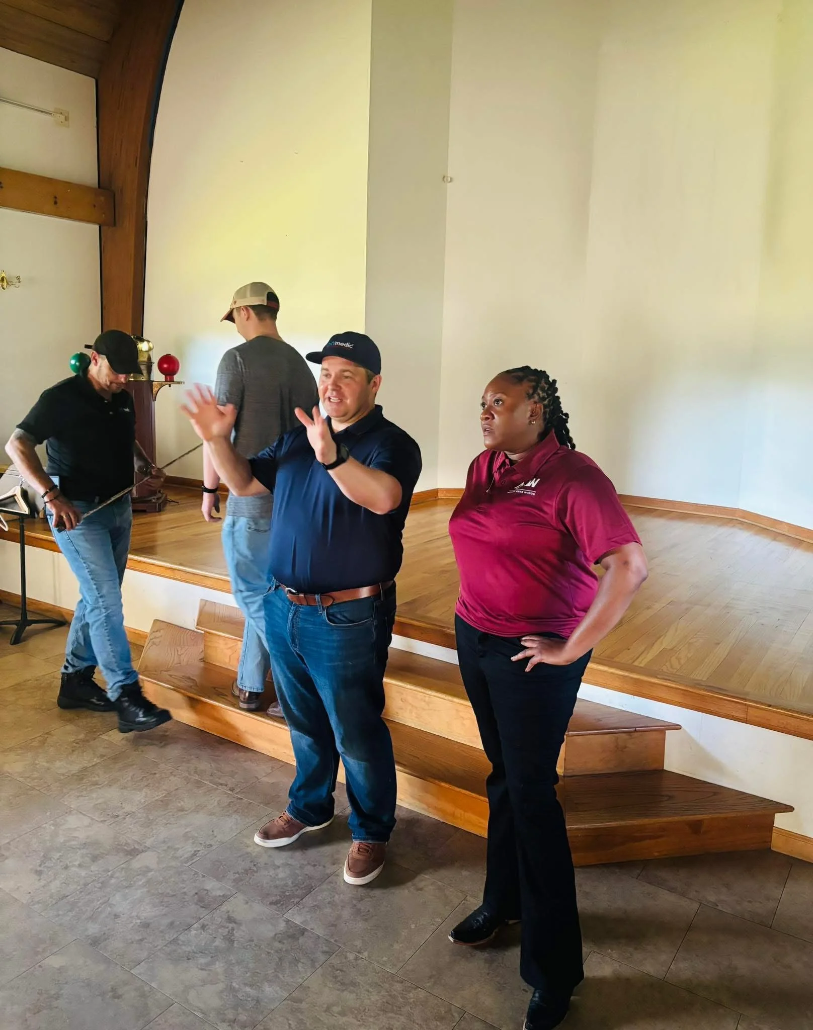 Group Discussion & Walkthrough: The team gathers in a room to coordinate and review key points, showing active communication and teamwork.