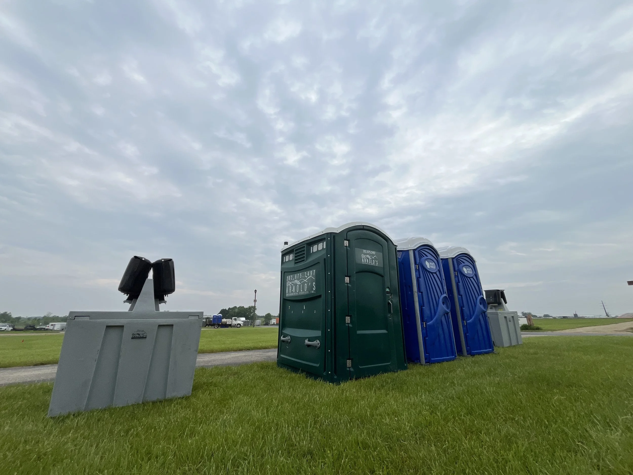 Arnold's Environmental portable restroom units and hand wash station set up at an outdoor event in southeastern Wisconsin