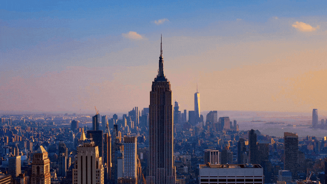 Empire State Building and New York City skyline at sunset.