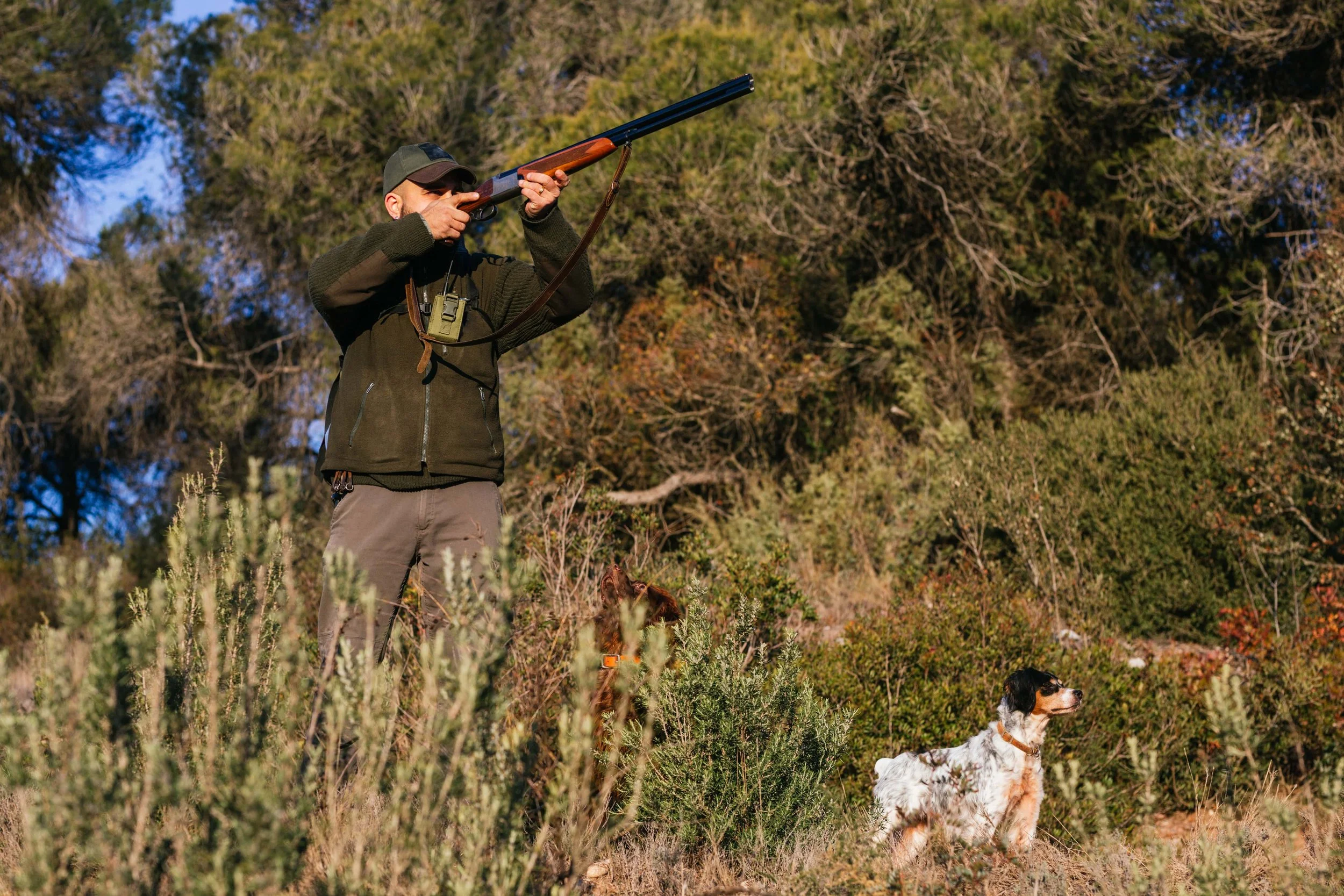 male-hunter-shooting-from-gun-during-hunt-with-dog-2023-11-27-05-27-43-utc-min.jpg