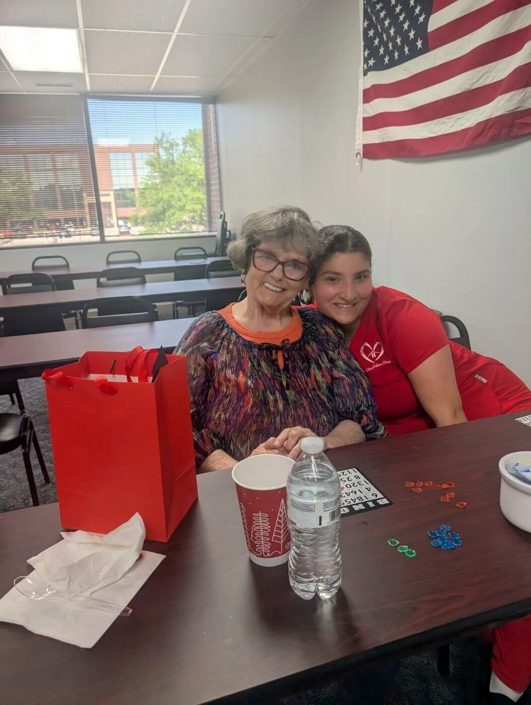 A StayHome.Care caregiver sharing a warm moment with a client