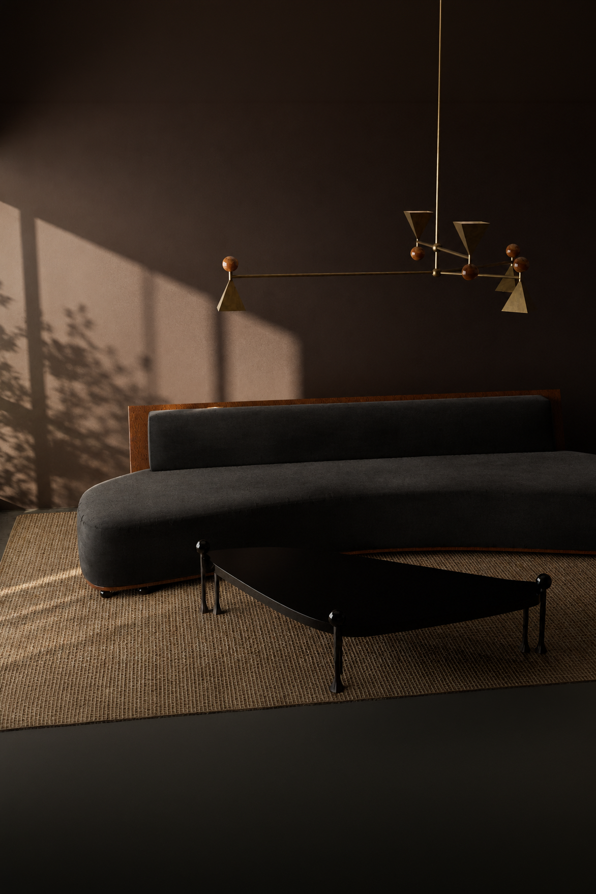 Modern living room with black curved sofa, black coffee table, and a suspended artistic chandelier with geometric shapes against a dark wall with shadows.