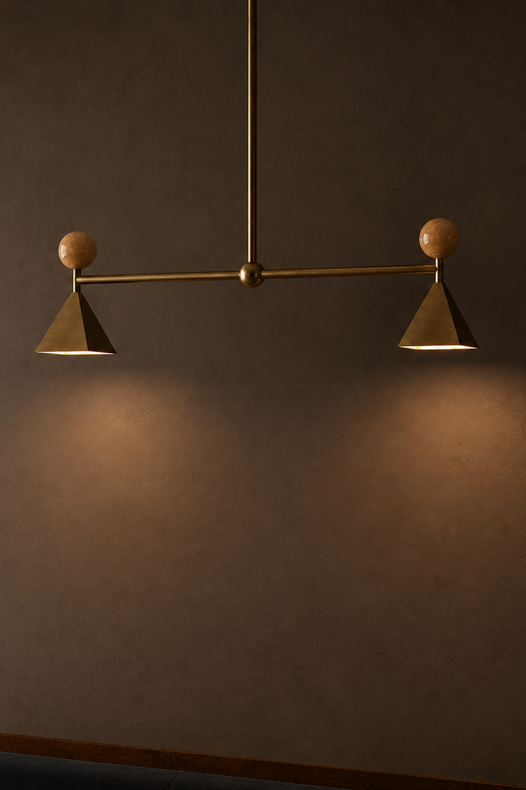 Modern wall light fixture with two angled lamps and spherical accents, mounted on a dark wall.