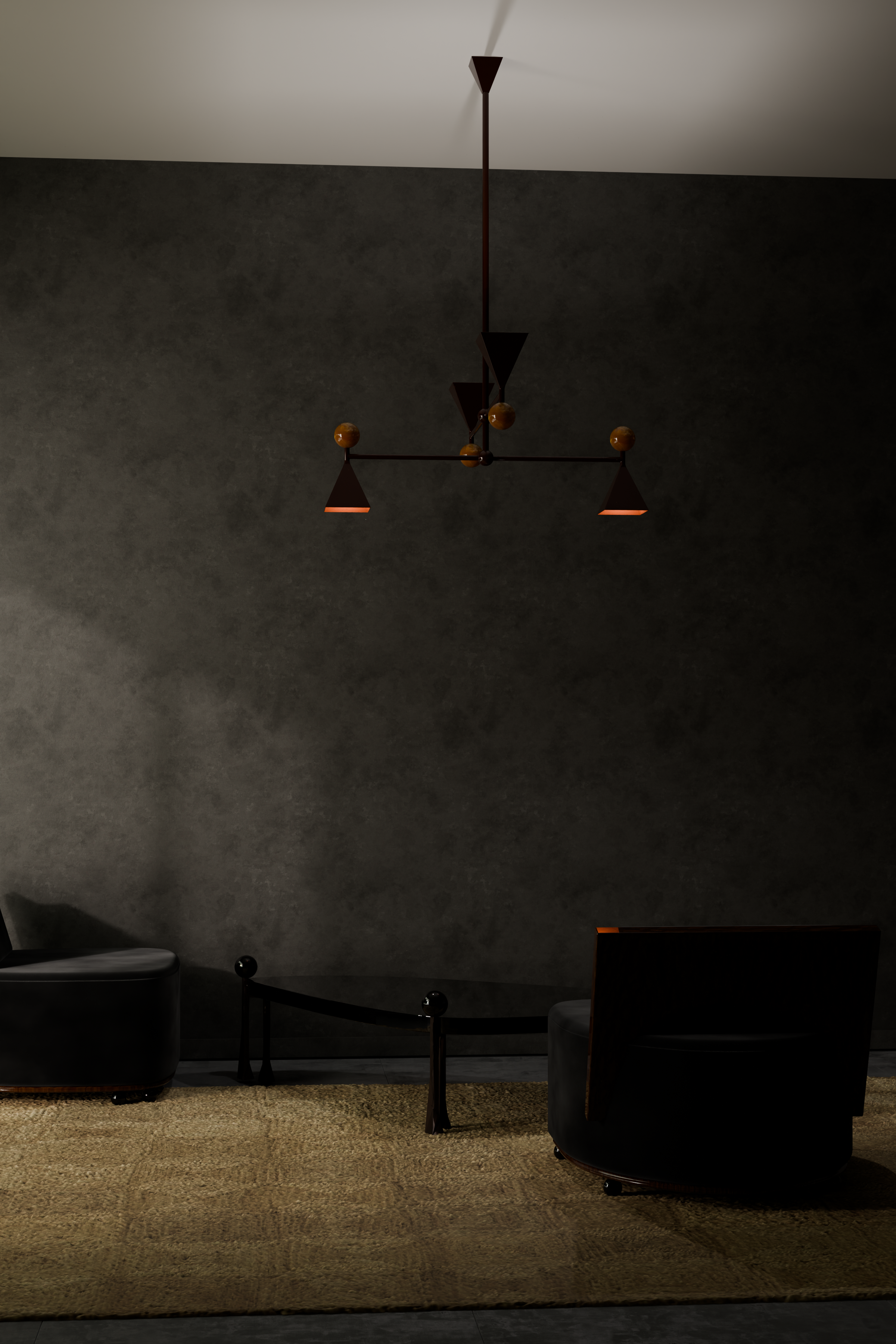 A modern living room with dark gray textured wall, a tan carpet, black furniture including a rounded chair, a small table, and two dining chairs, illuminated by a vintage-style chandelier hanging from the ceiling.
