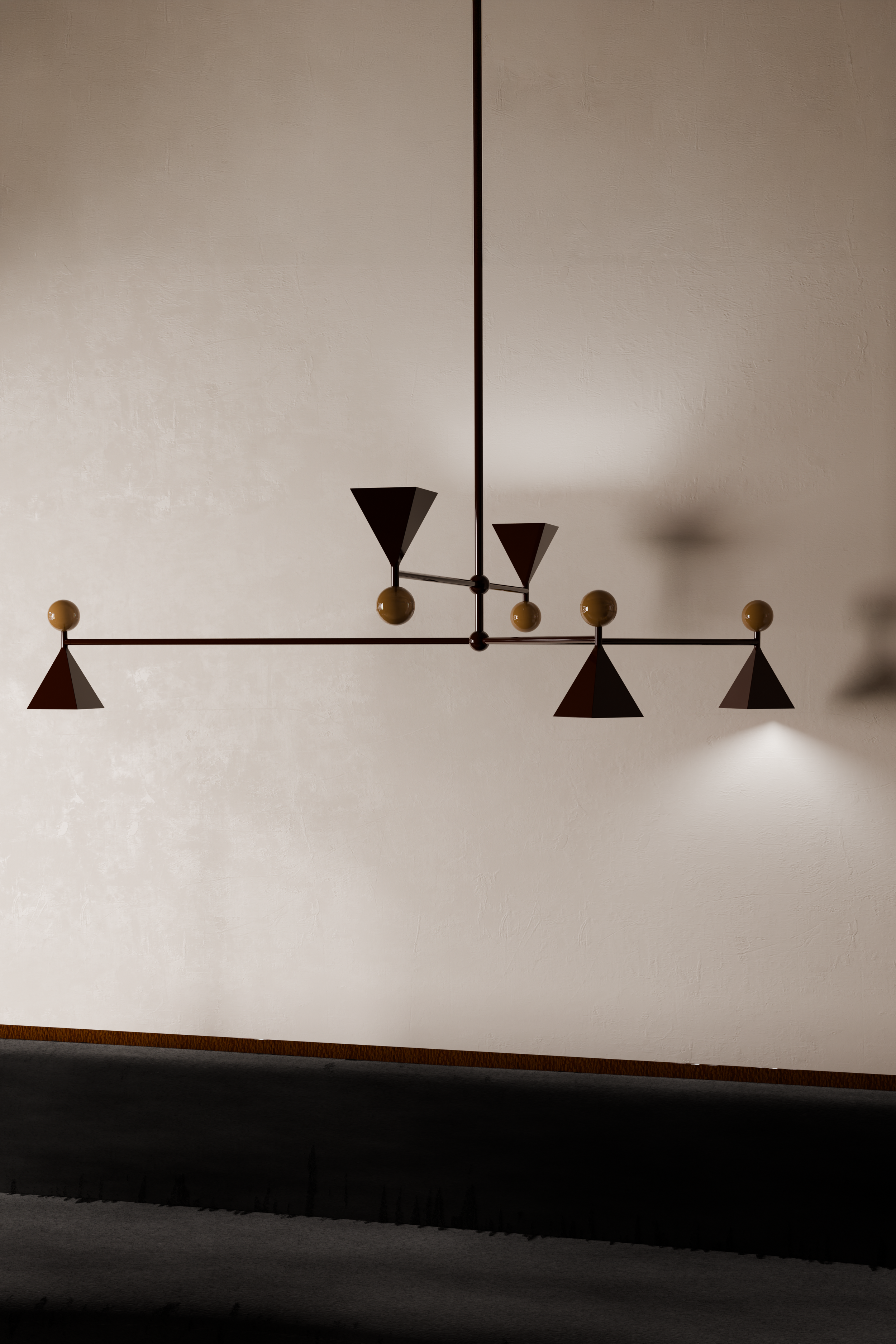 A modern chandelier with black geometric shapes and yellow spherical accents hanging against a textured off-white wall.