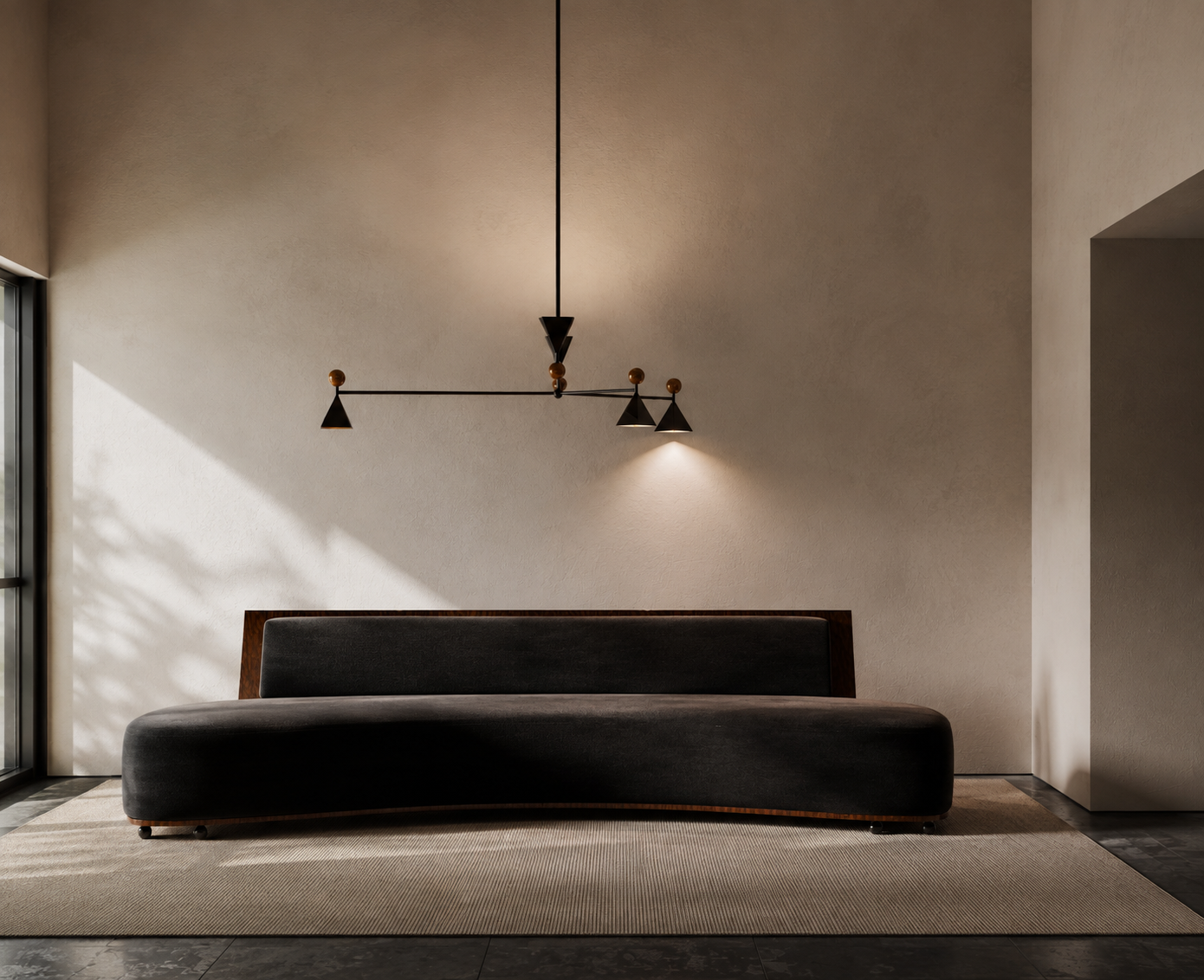 Minimalist living room with a black sofa, a modern black and wood chandelier, and beige walls illuminated by natural light from a left window.