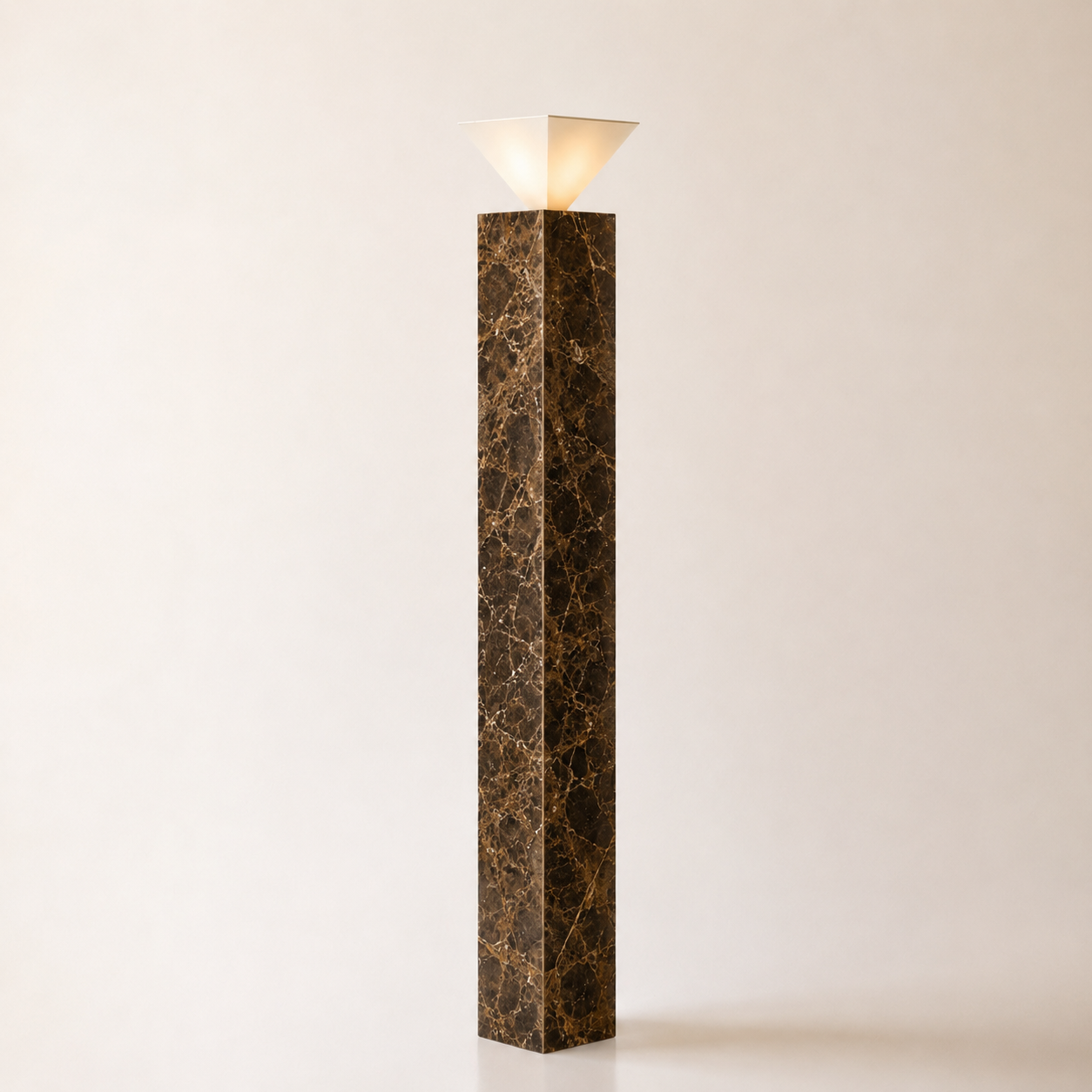 A tall rectangular lamp with a dark marble base and a white, cone-shaped shade on top, against a light background.