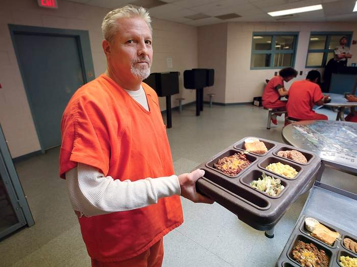 Image of an inmate holding a food tray at the La Plata County jail