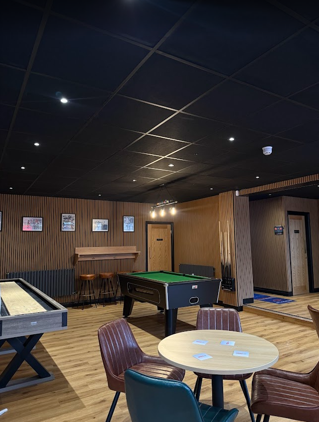 Recreational area of the Hickey's & Friends bar in Barnoldswick, Lancashire featuring a pool table, shuffle board, darts and plenty of seating.