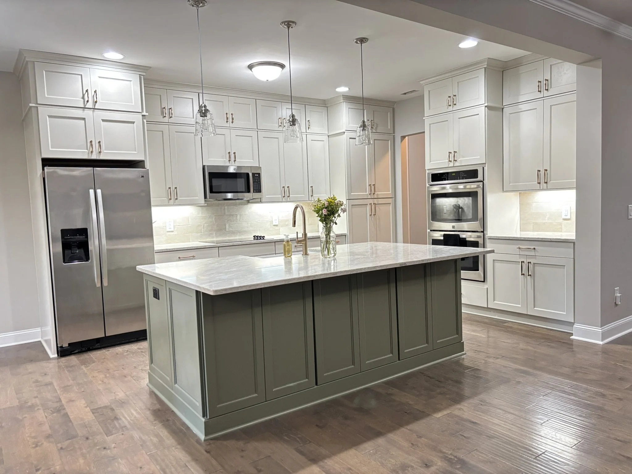 Integrity (Island) -- Southporte full overlay shaker door, Sage. Marsh (Perimeter) -- Sedgefield full overlay shaker door, Salt.