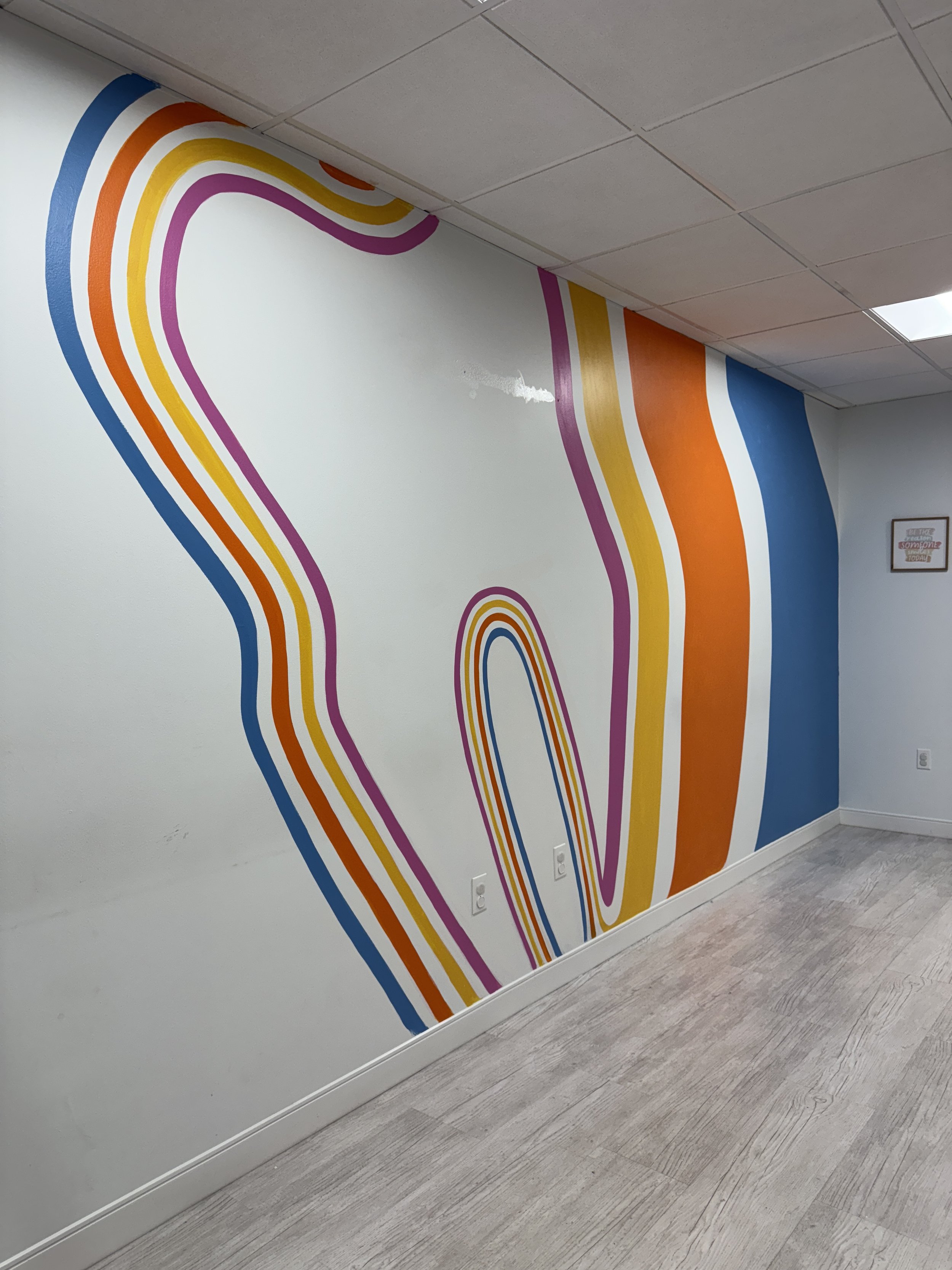 Mural of a tooth with colorful lines around it