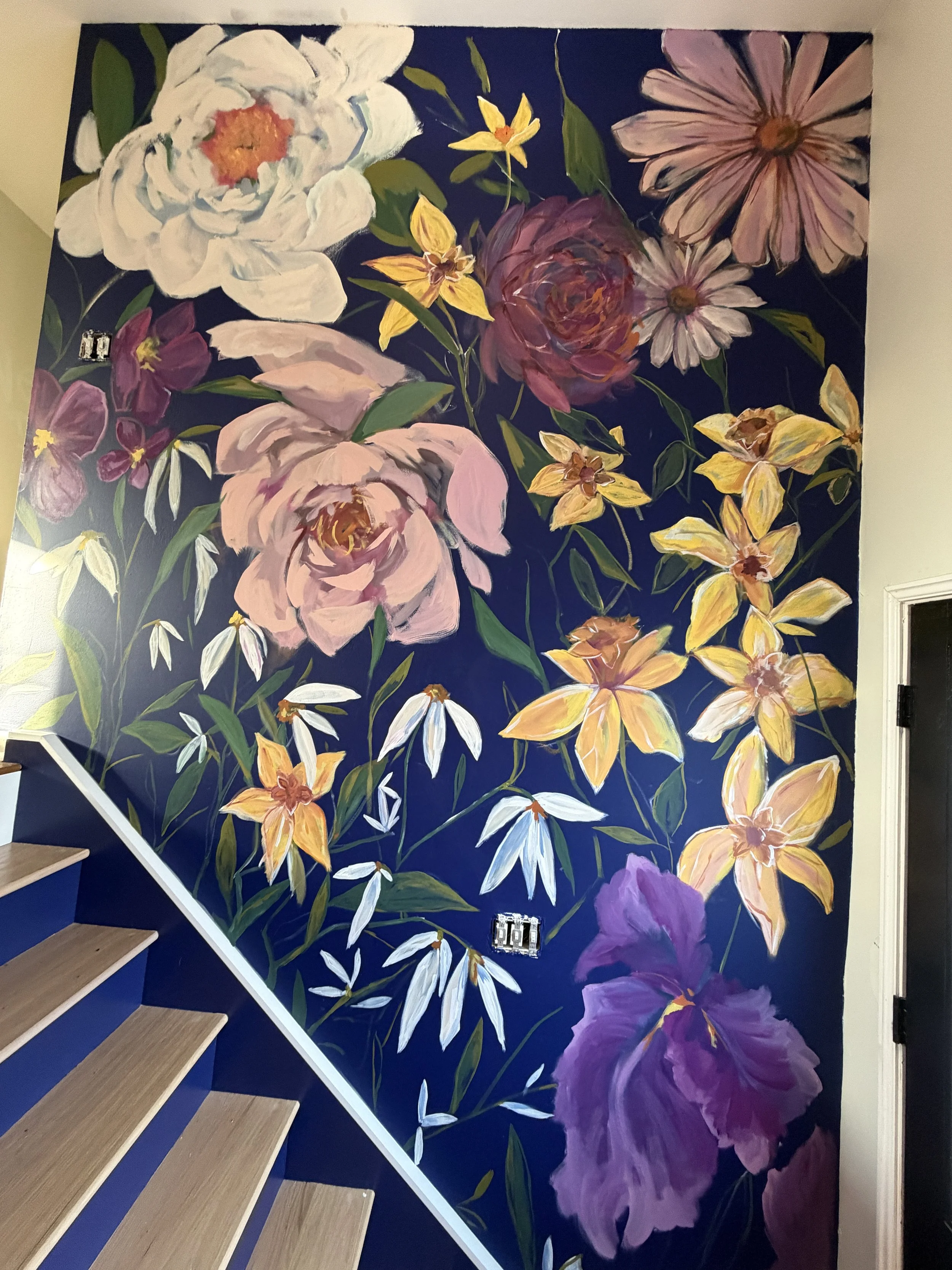 Mural of flowers and foliage against a dark navy blue background
